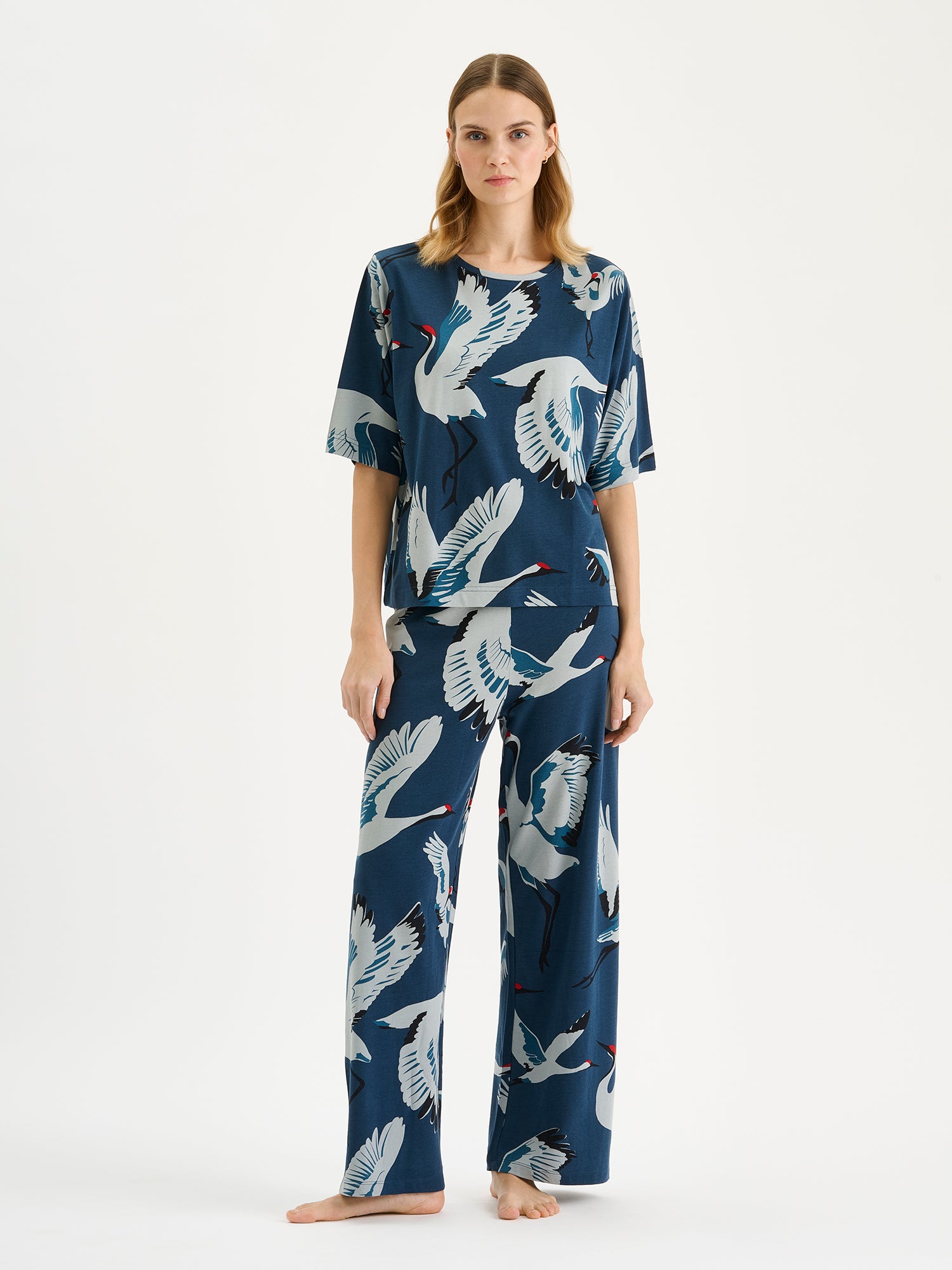 Nanso women's relaxed and straight-cut women's loungewear t-shirt featuring a charming Kurki pattern in elegant blue on a model with matching pants