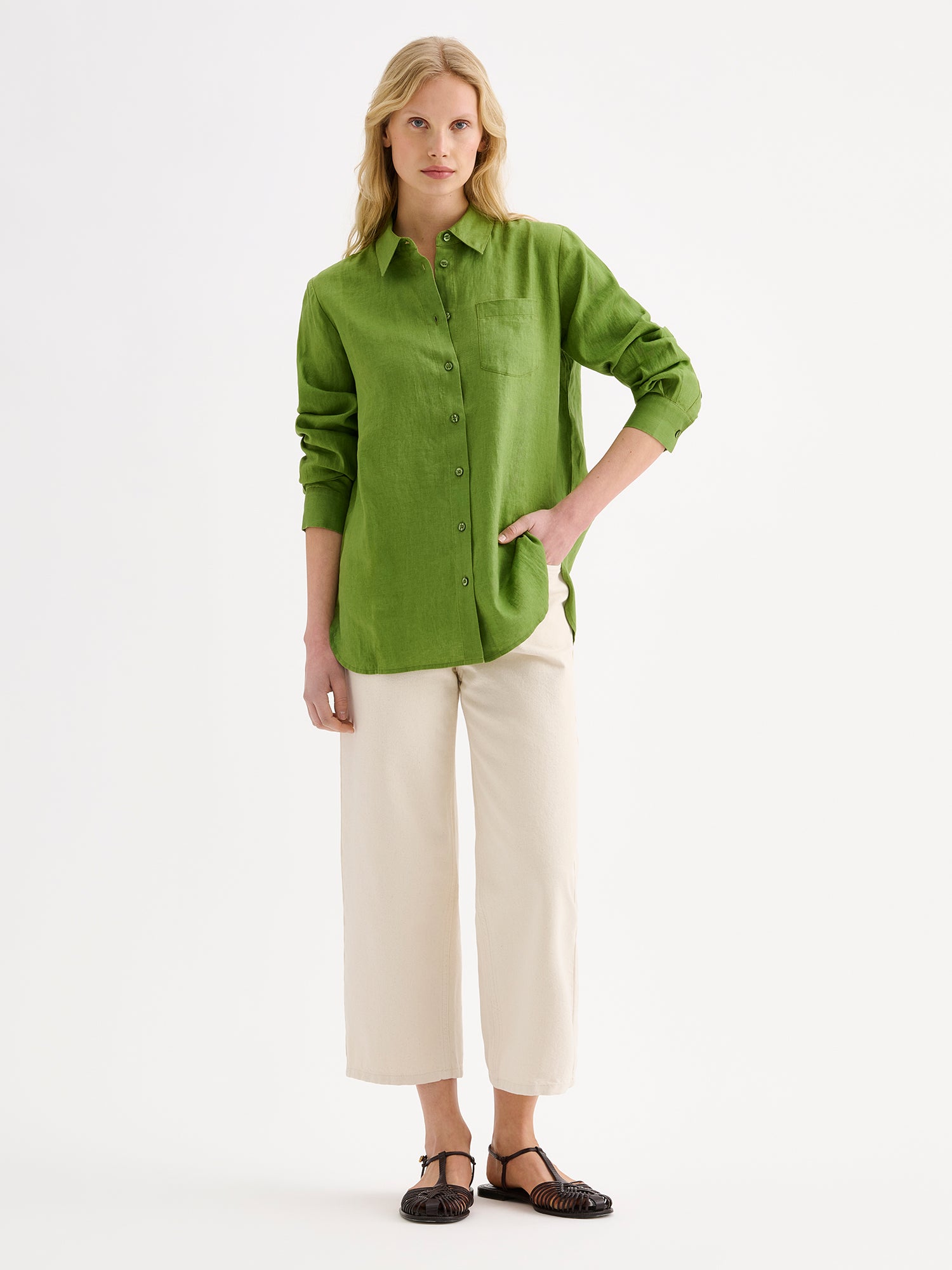 Nanso women's relaxed, classic and versatile green Lene linen shirt is crafted from woven linen fabric that is durable and breathable. The shirt features a front button closure and chest pocket and full-length sleeves.