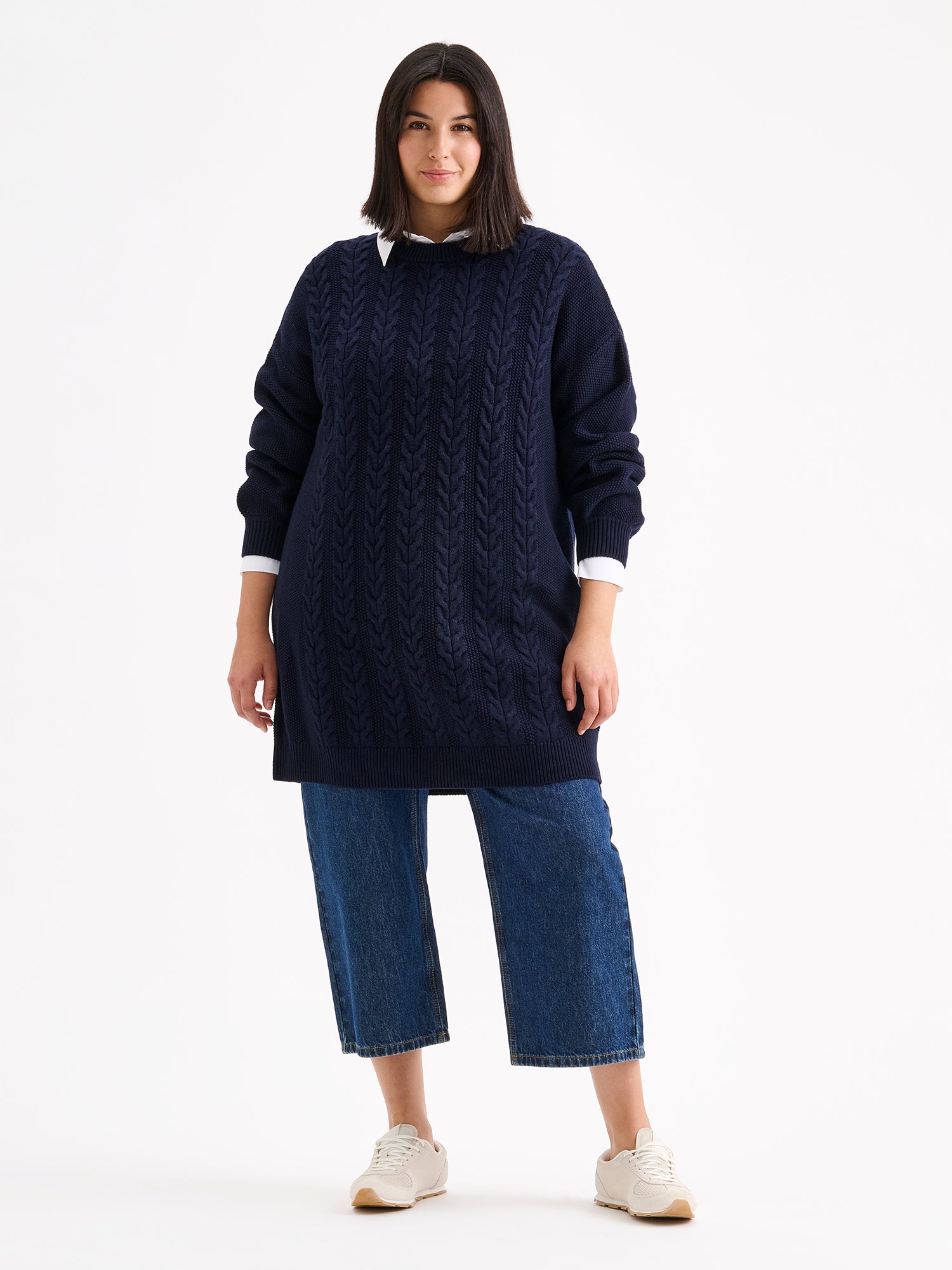 Nanso women's generous dark blue Palmikot knit dress on a model with wide blue jeans