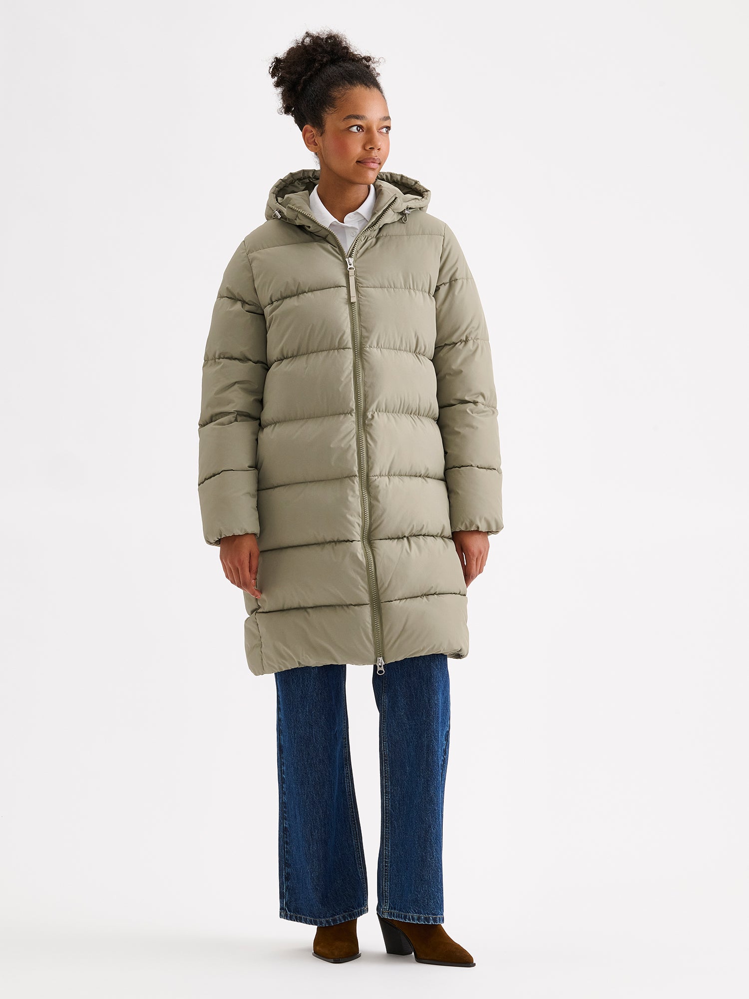 Nanso women's warm, padded yet pleasantly lightweight Lumi midi puffer coat on a model with jeans