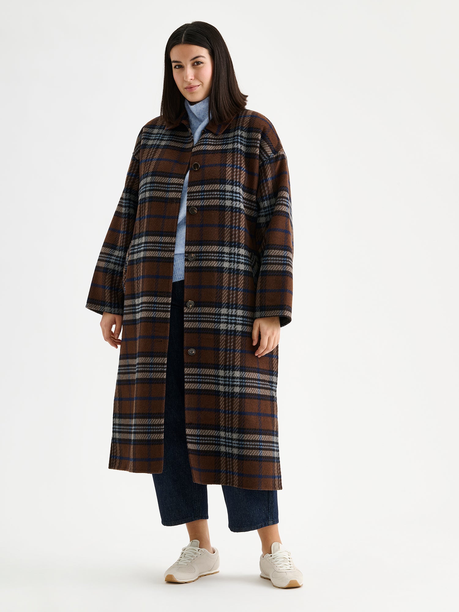 The stylish and timeless Astrid wool coat features a contemporary checked pattern, pictured on a model 