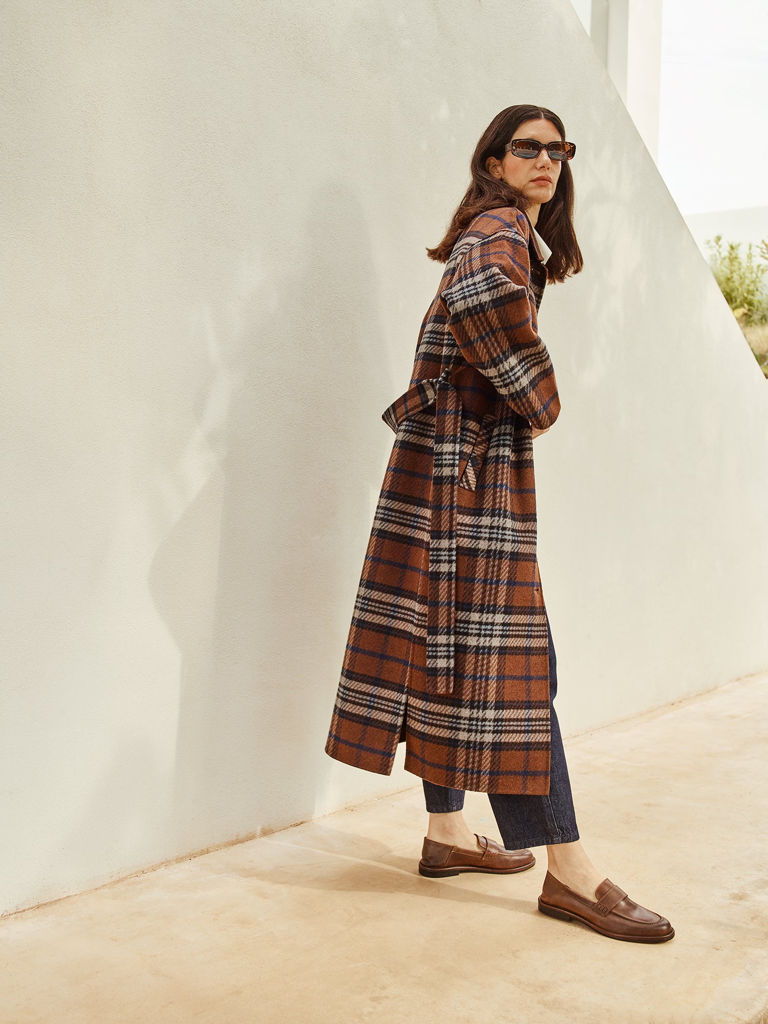 The stylish and timeless Astrid wool coat features a contemporary checked pattern, pictured on a model 