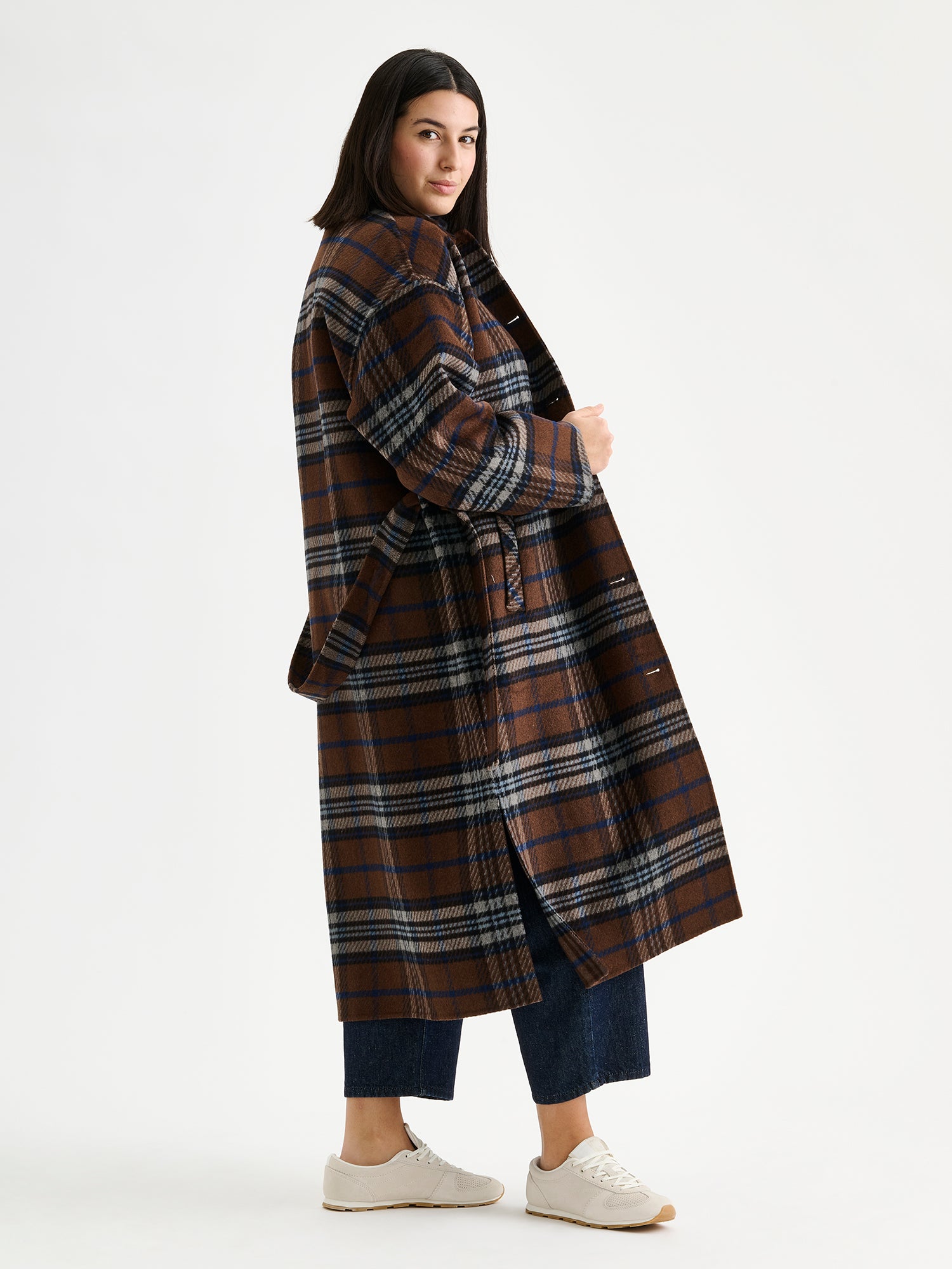 The stylish and timeless Astrid wool coat features a contemporary checked pattern, pictured on a model 
