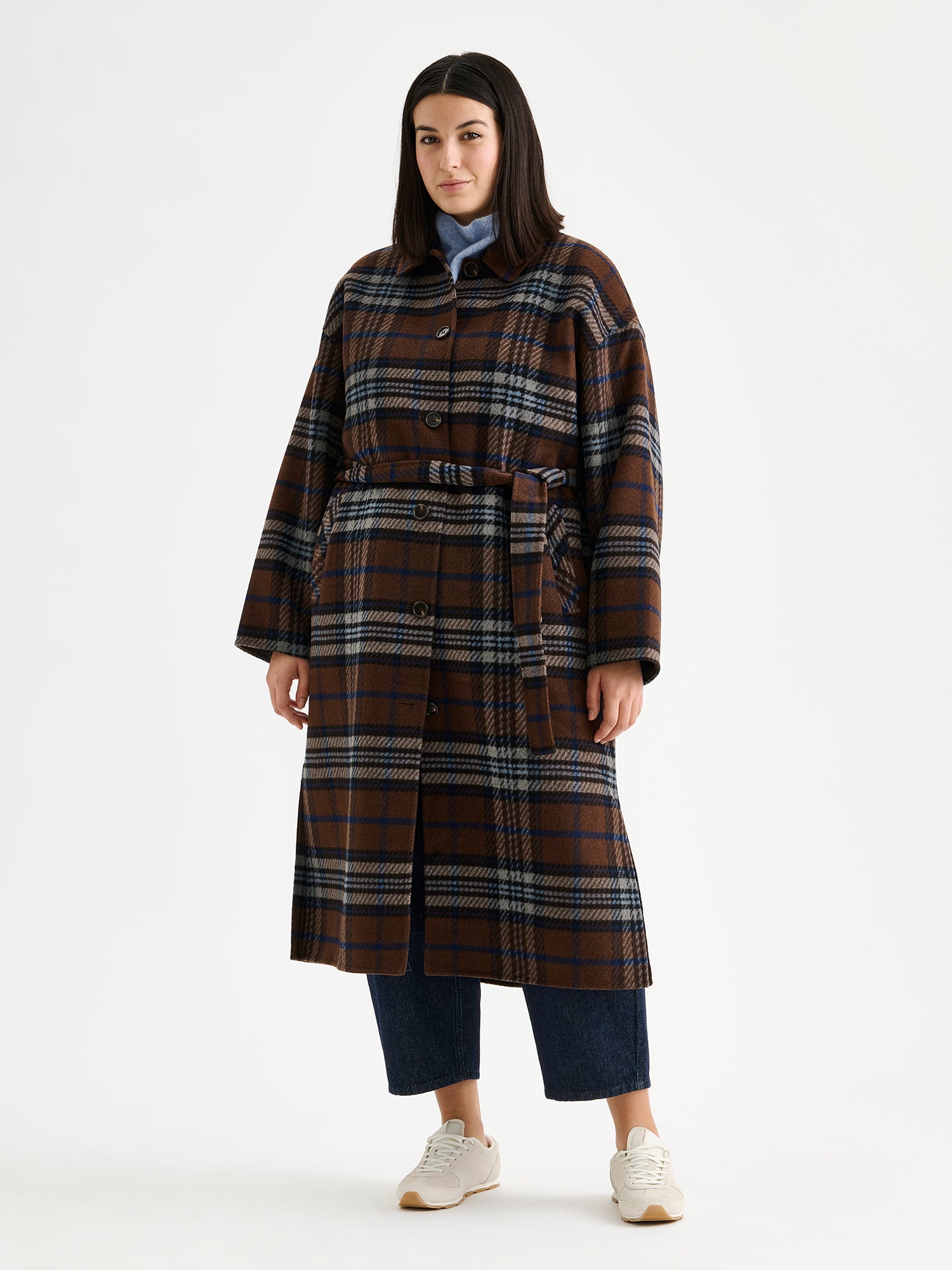 The stylish and timeless Astrid wool coat features a contemporary checked pattern, pictured on a model 