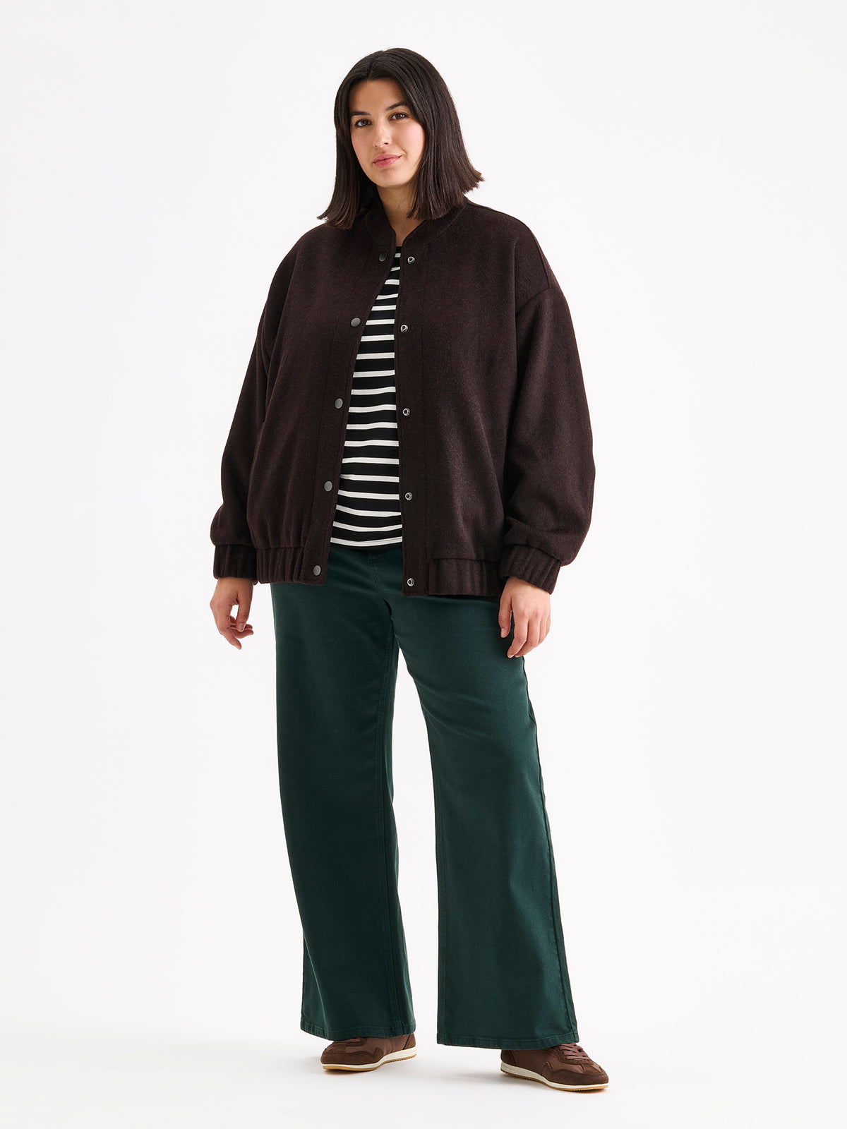 Nanso women's Tove wool bomber jacket in a rich brown shade combines the relaxed look of a bomber jacket with the timeless elegance of wool, on a model.