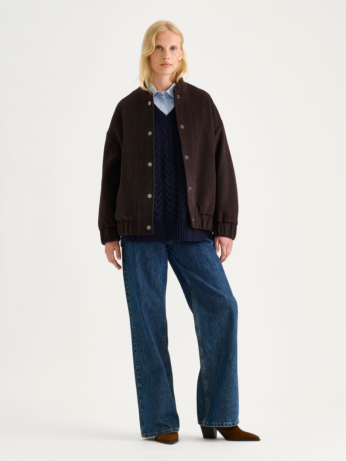 Nanso women's Tove wool bomber jacket in a rich brown shade combines the relaxed look of a bomber jacket with the timeless elegance of wool, on a model.