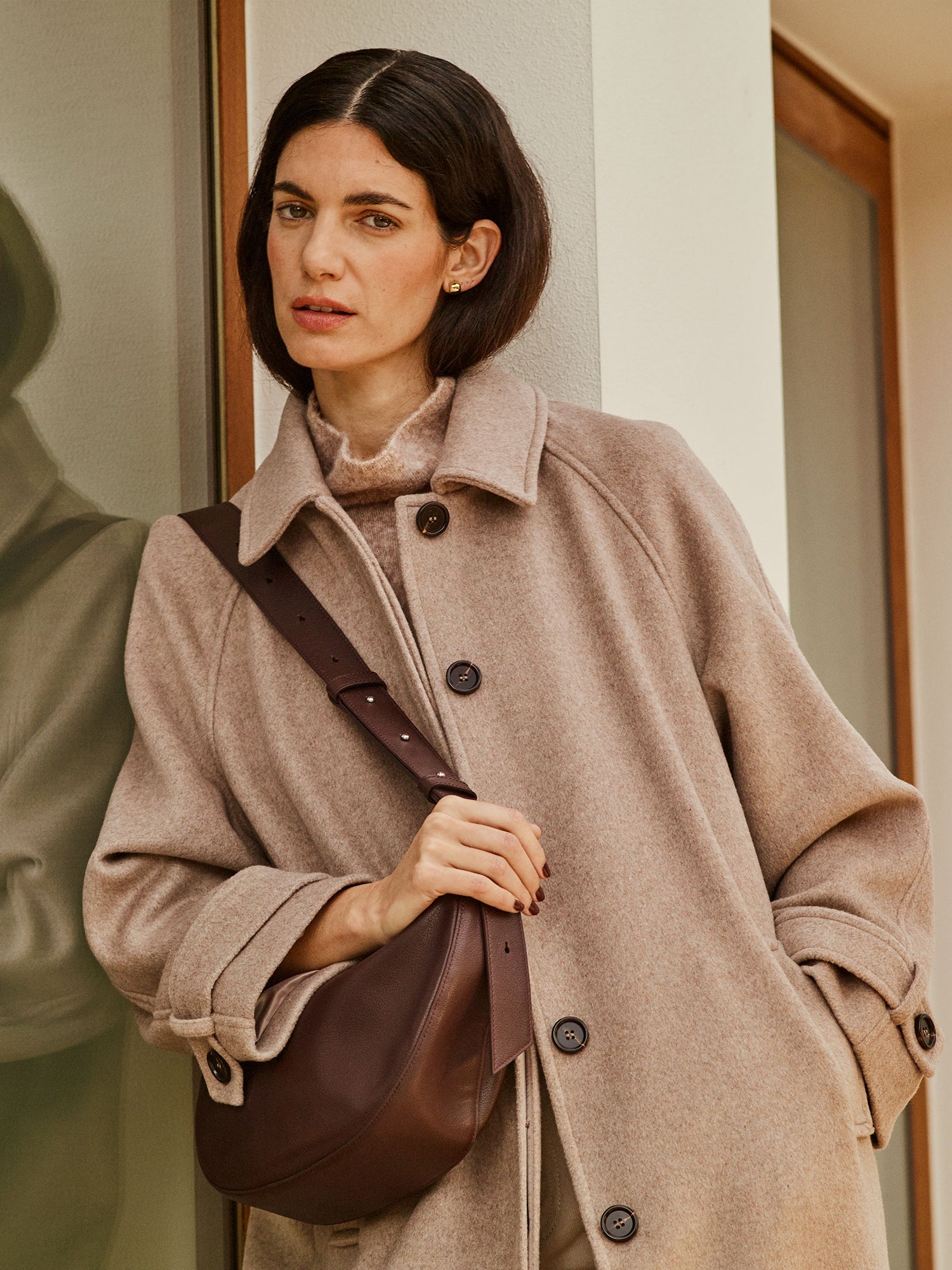 Nanso women's timelessly elegant and effortlessly classic, the Tove long wool coat in beige, on a model close-up