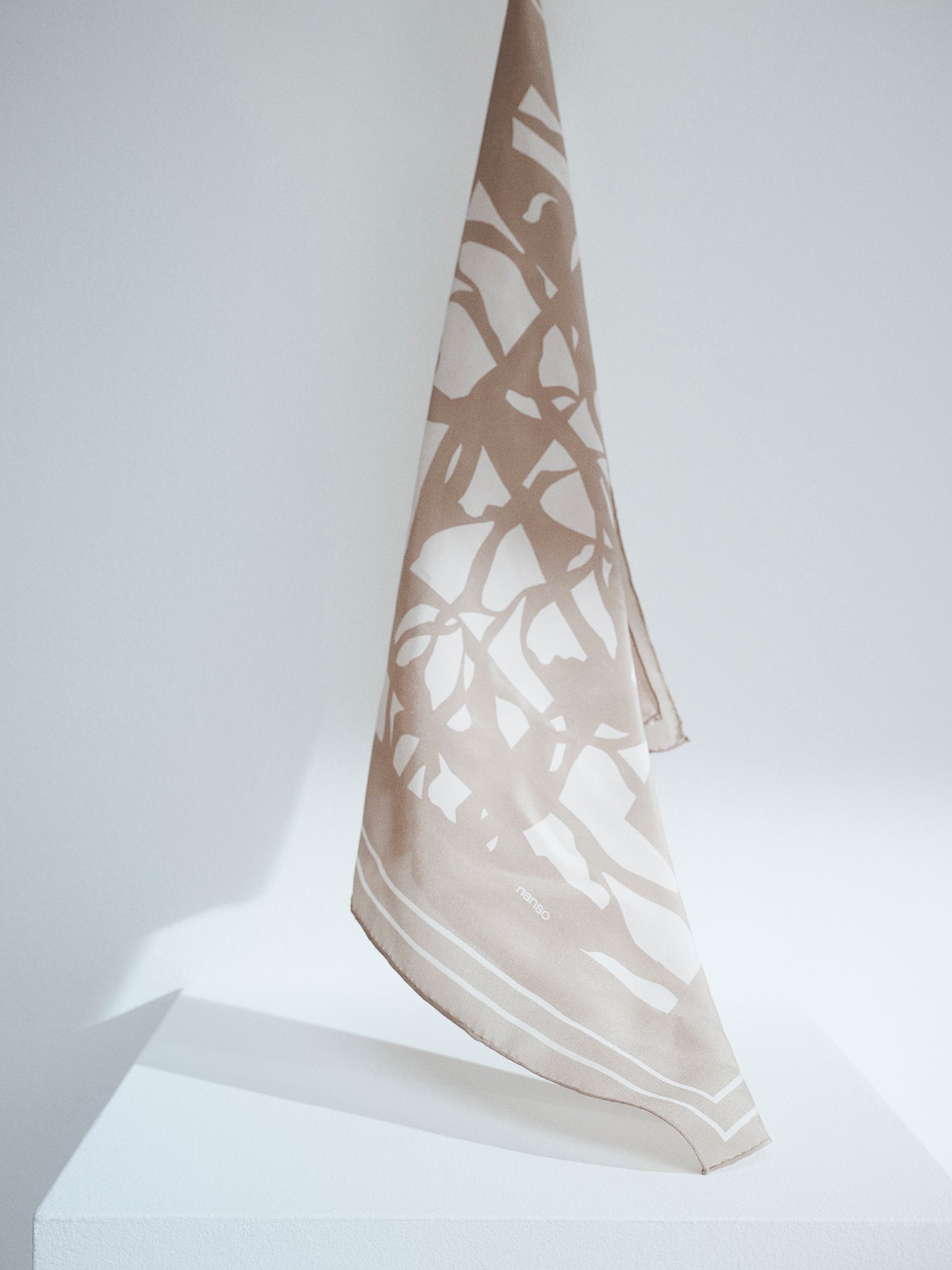 Palsta sophisticated patterned silk scarf in a product picture.