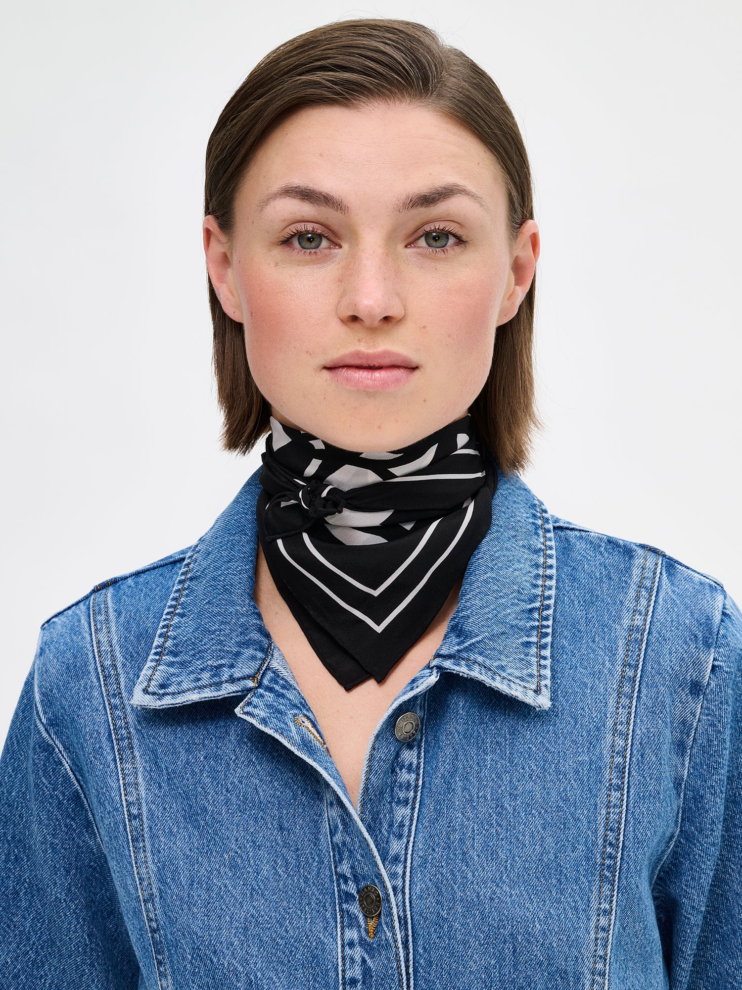 Palsta sophisticated patterned silk scarf in black and white on a model with a denim jacket