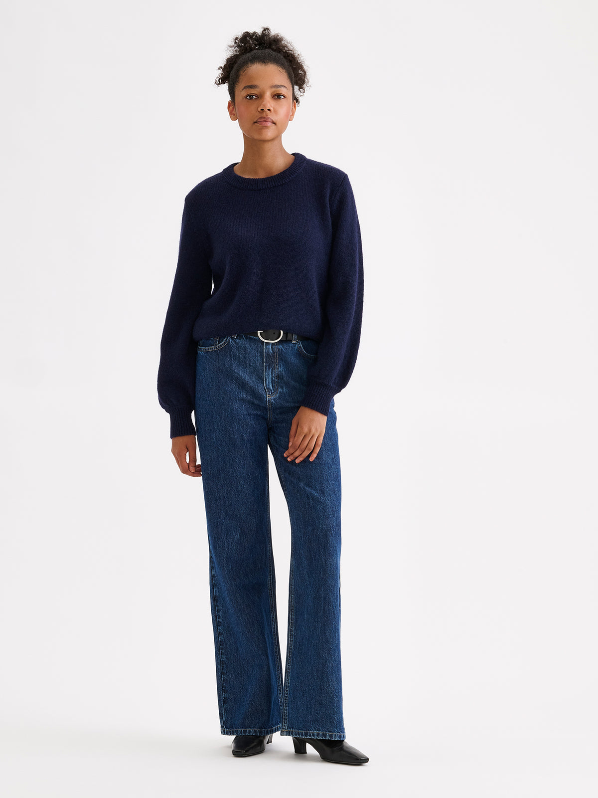 Nanso women's Lotte knitted sweater in a timeless blue shade on a model with jeans | S - 177cm