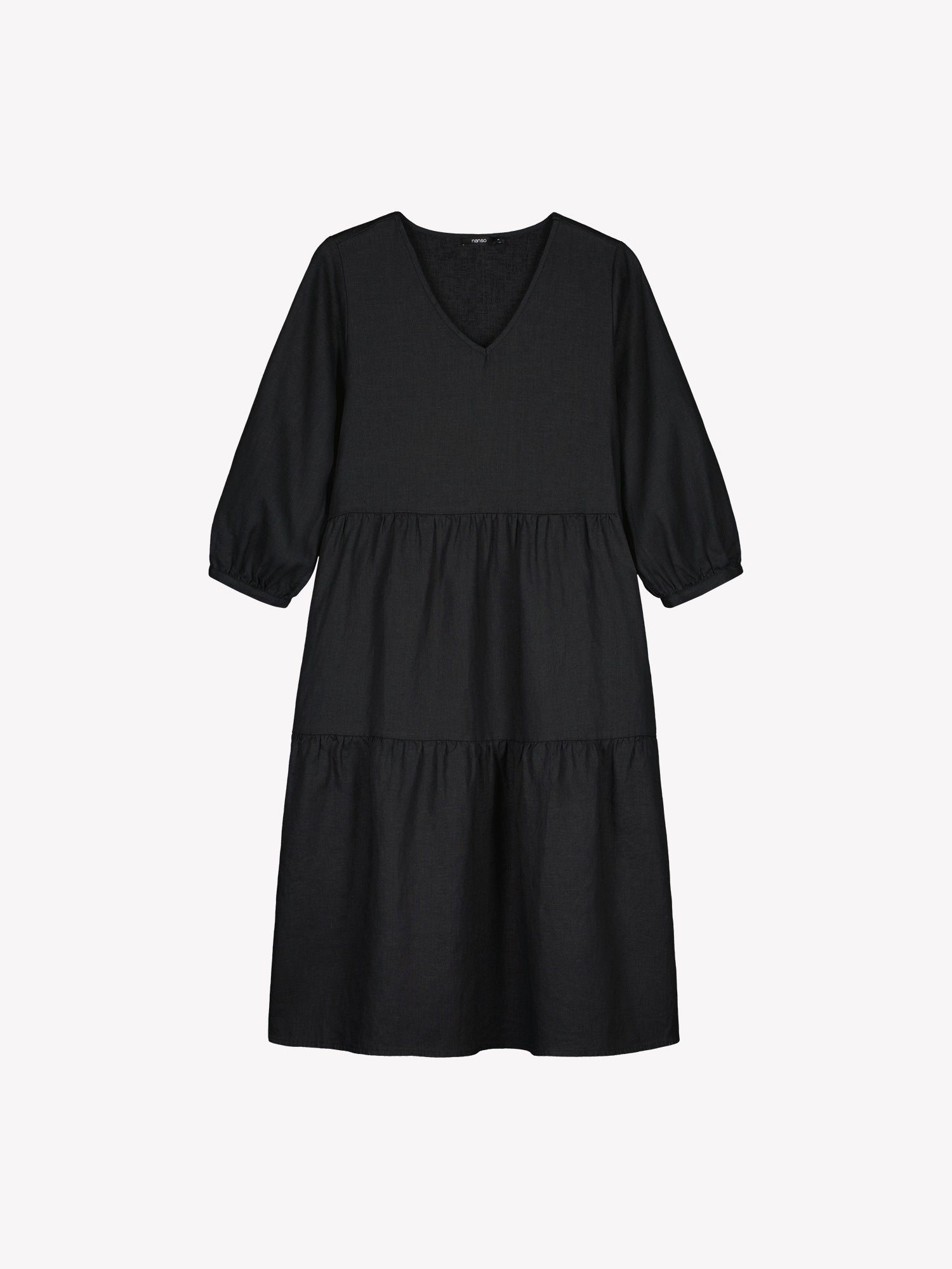 Nanso women's SARALIVIA linen dress in black features charming layered ruffles, 3/4 sleeves, side pockets and a V-neckline. Product picture from the front
