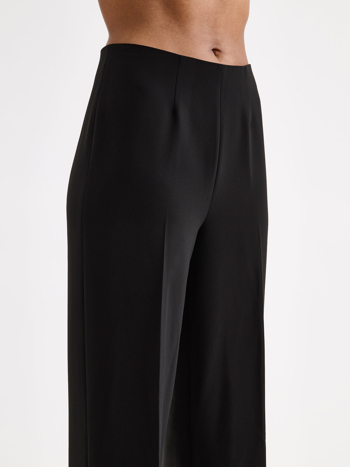 Nanso women’s black Avelia culottes trousers with pockets and pressed creases, on a model