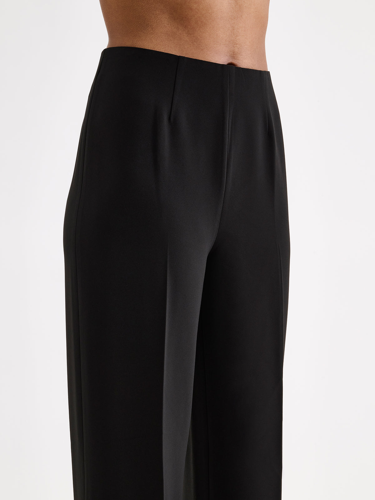 Nanso women’s black Avelia trousers with pockets and pressed creases, on a model