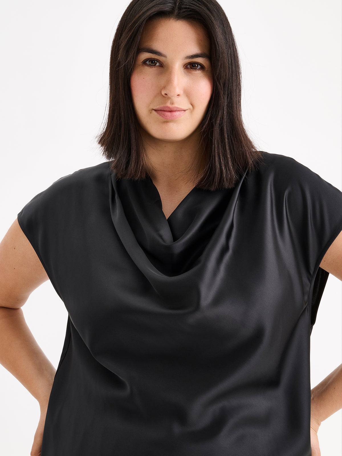 Nanso women's elegant Silva satin blouse in a classic black  shade on a model with matching satin trousers.