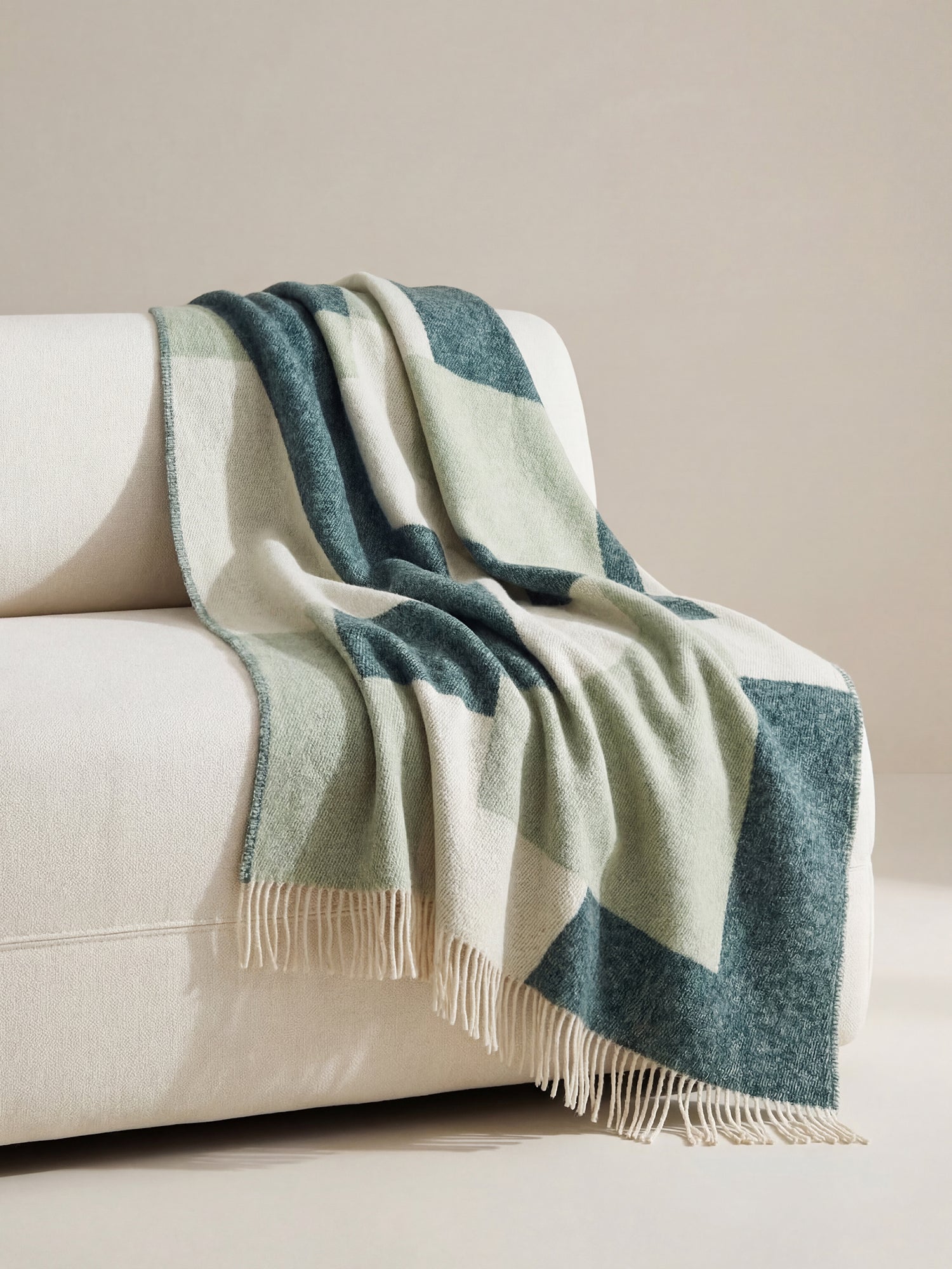 TAIDE Wool Blanket, crafted from 100% new, virgin wool in a stylish green toned design, in a cosy home decor picture
