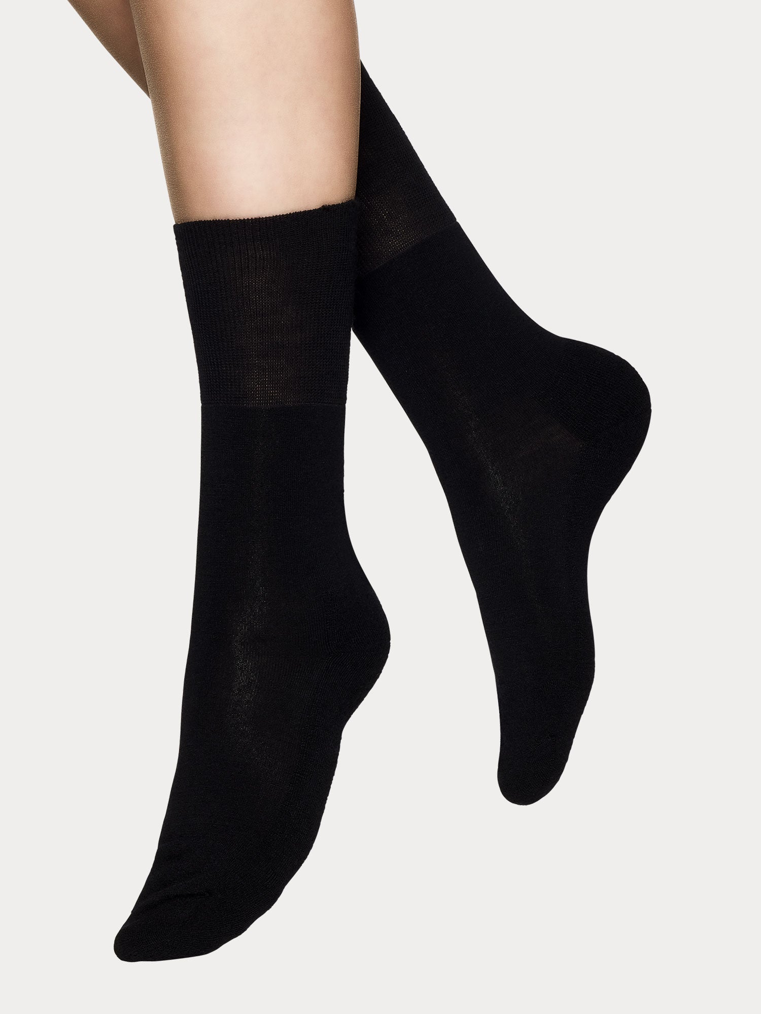 Vogue women's black merino wool ankle socks with soft terry sole and seamless toe construction, pictured on a model