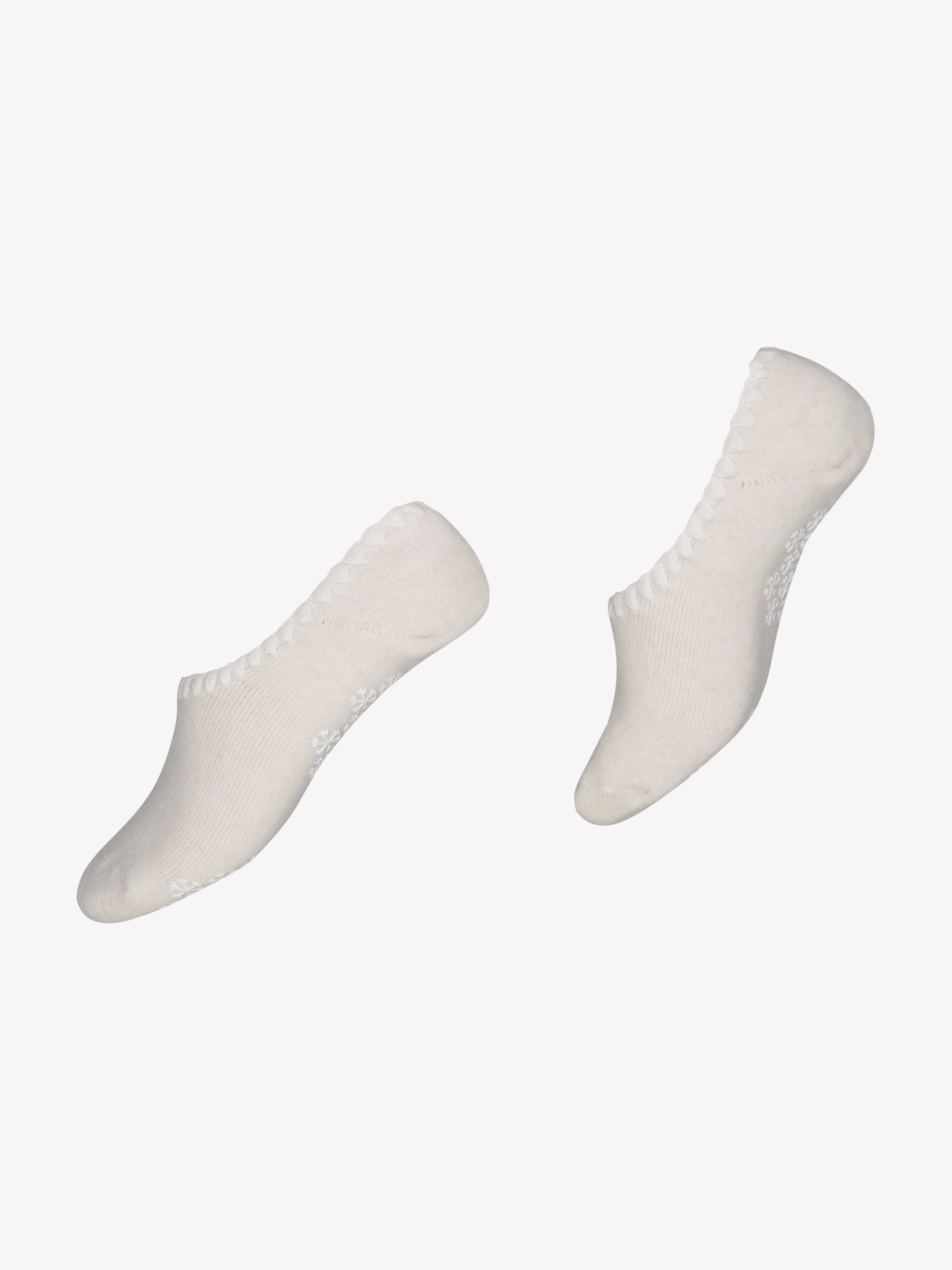 Vogue's soft wool blend no-show socks in off-white in a product picture. Featuring a delicate feminine edge detail and tiny snowflake anti-slip print on sole.