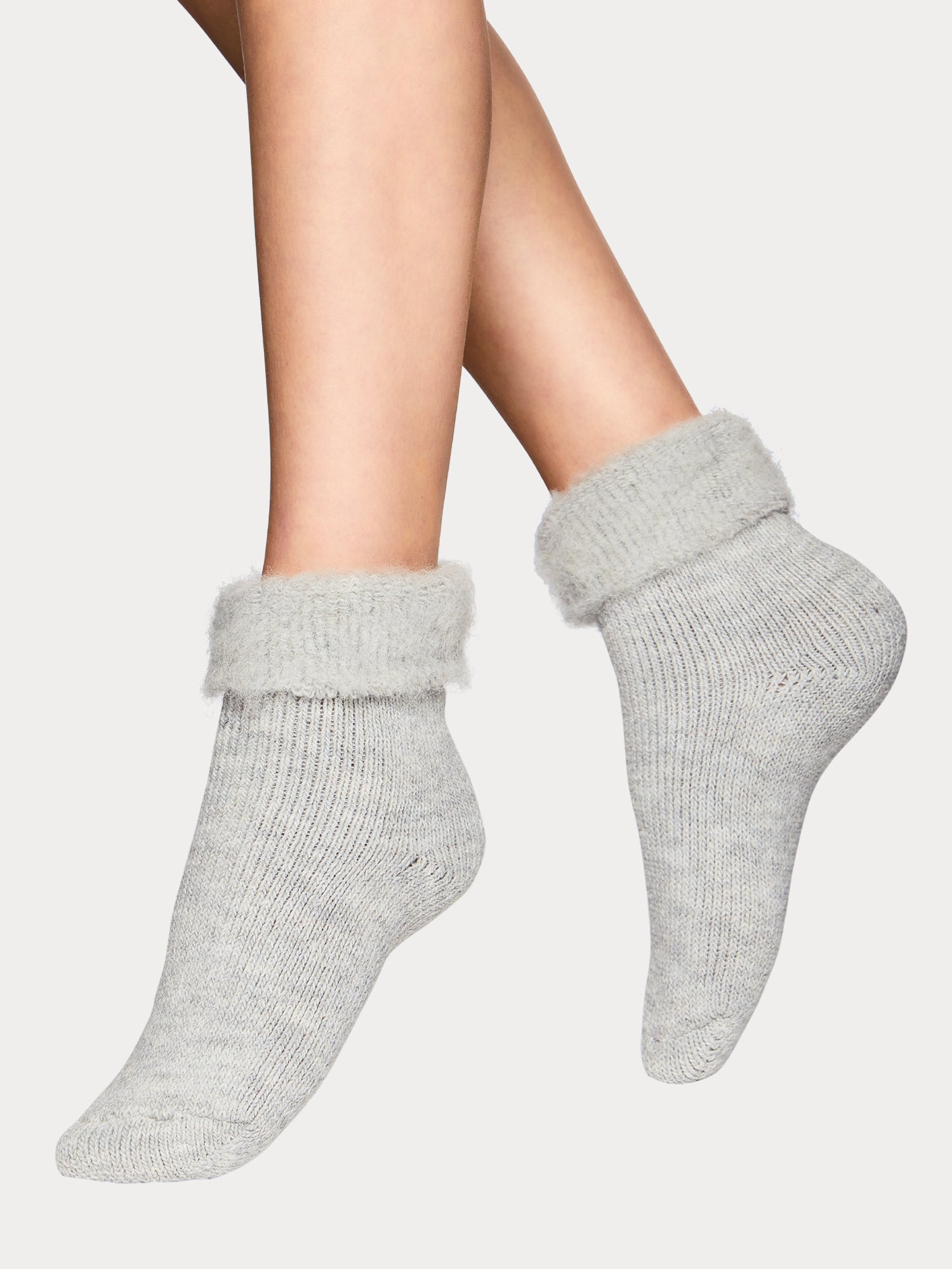 Nanso grey alpaca wool blend home socks with fluffy inside, ankle-length, worn by model on feet in full-body view.