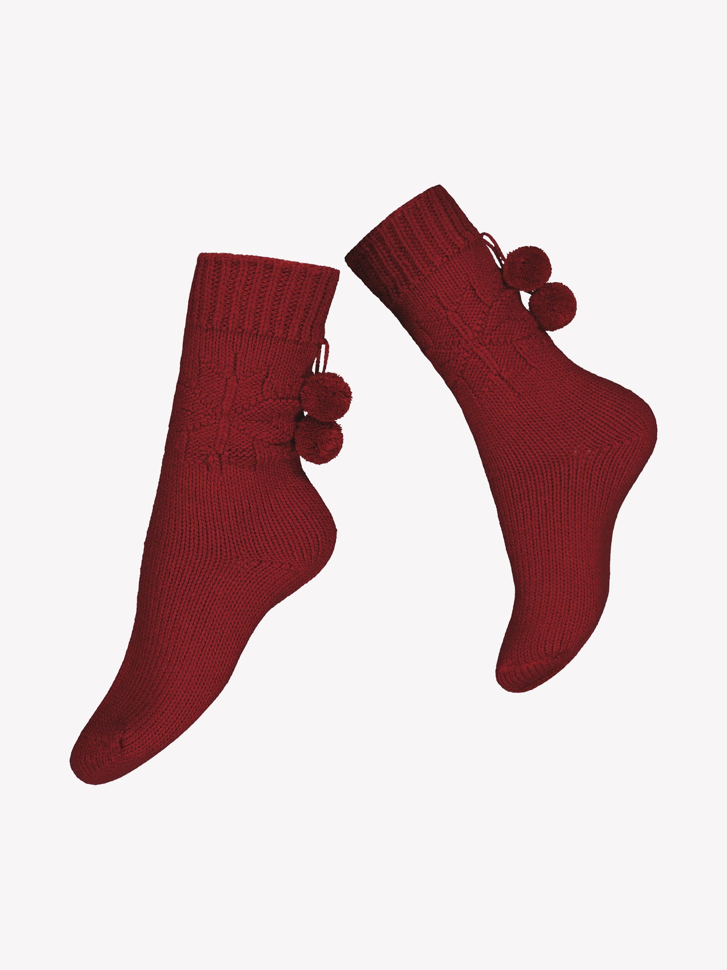 Vogue's wool blend socks in a cranberry red color with snowflake pattern on the ankle and pompoms placed in a product picture.