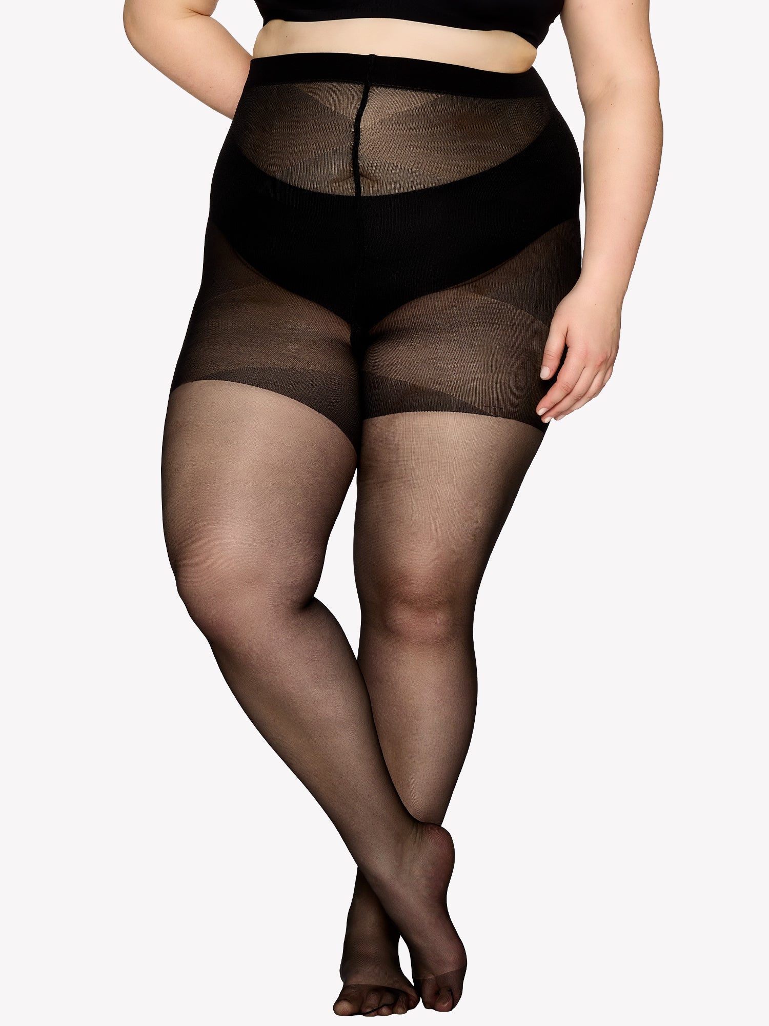 Vogue women's Curvy black 20 denier semi-matte tights for curvy figures. The elastic waistband sits comfortably, while the lightweight gusset design ensures easy dressing. On a model.