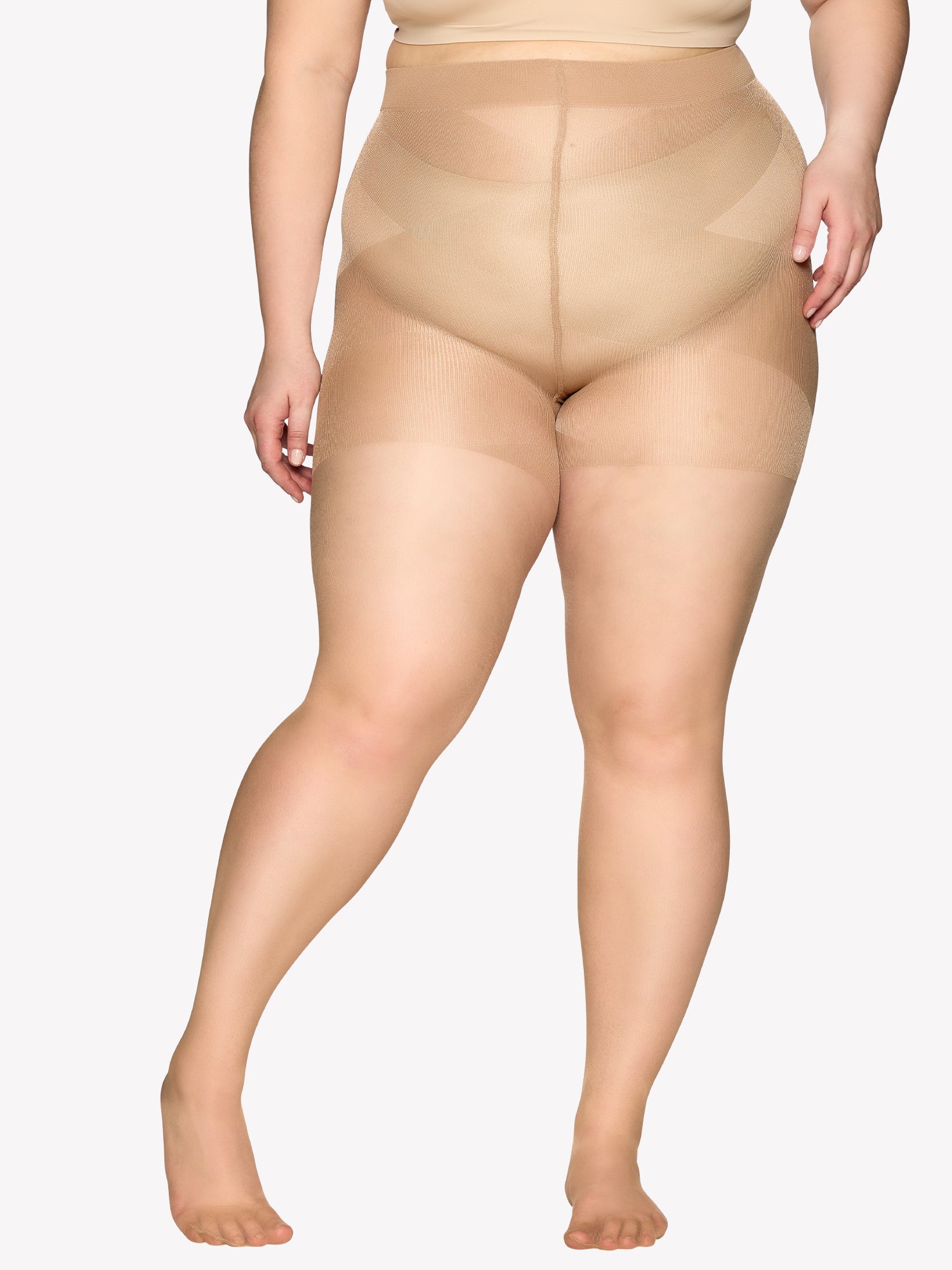 Vogue women's Curvy 20 denier semi-matte tights for curvy figures. The elastic waistband sits comfortably, while the lightweight gusset design ensures easy dressing. Pictured on a plus size model from the front.