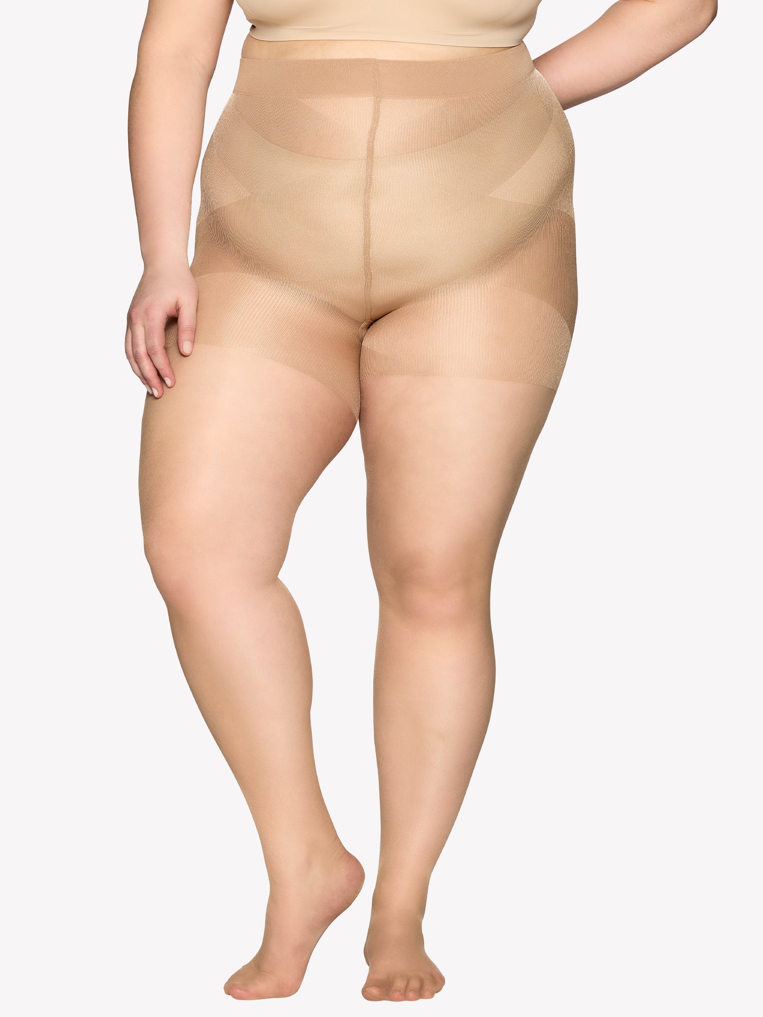 Vogue women's Curvy 20 denier semi-matte tights for curvy figures. The elastic waistband sits comfortably, while the lightweight gusset design ensures easy dressing. Pictured on a plus size model.