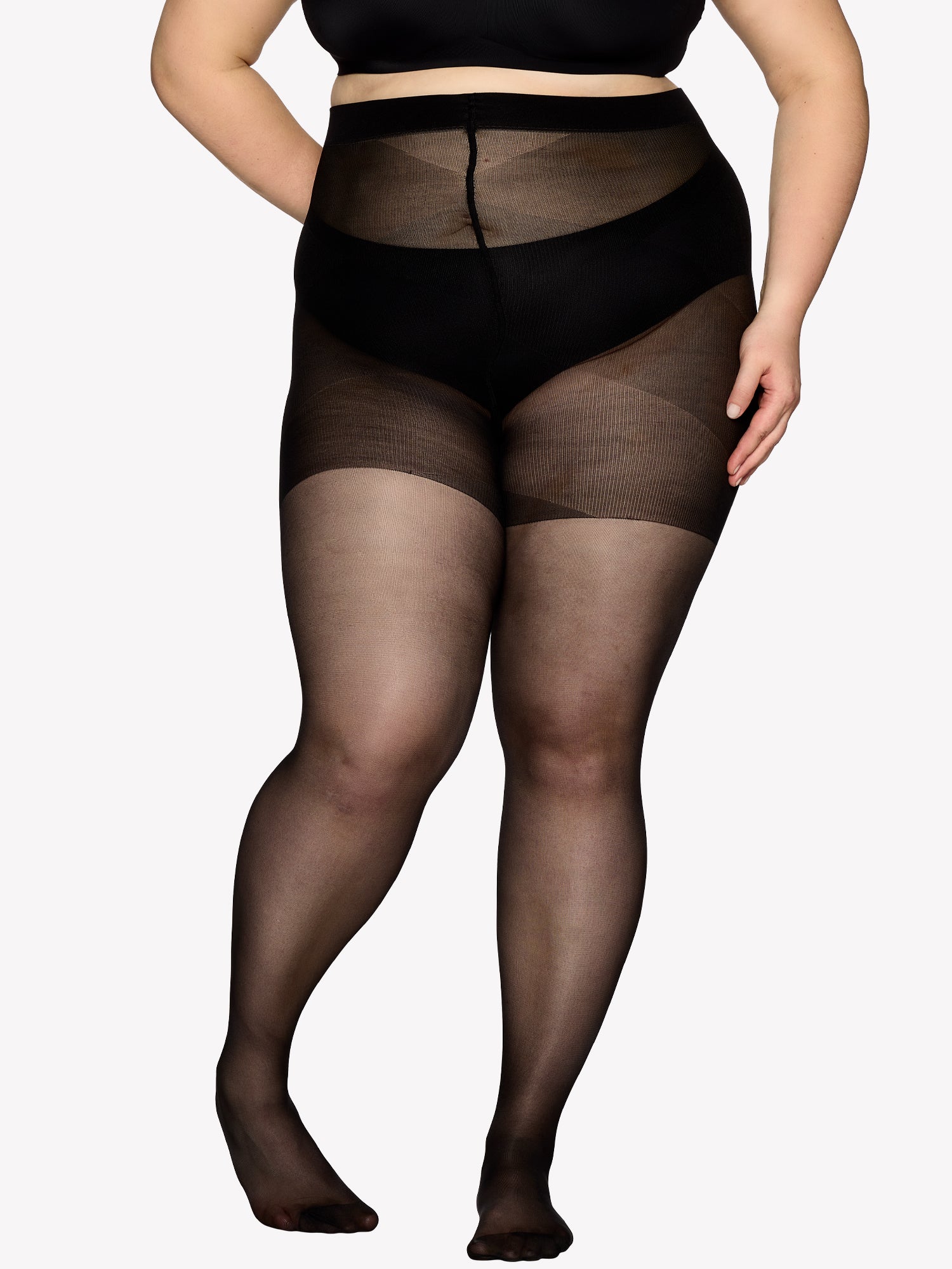 Vogue women's Curvy 40 denier sheer semi-matte tights, expertly crafted for curvy figures with elastic waistband  and a light panty part without panel gusset. On a model in shade black from the front.