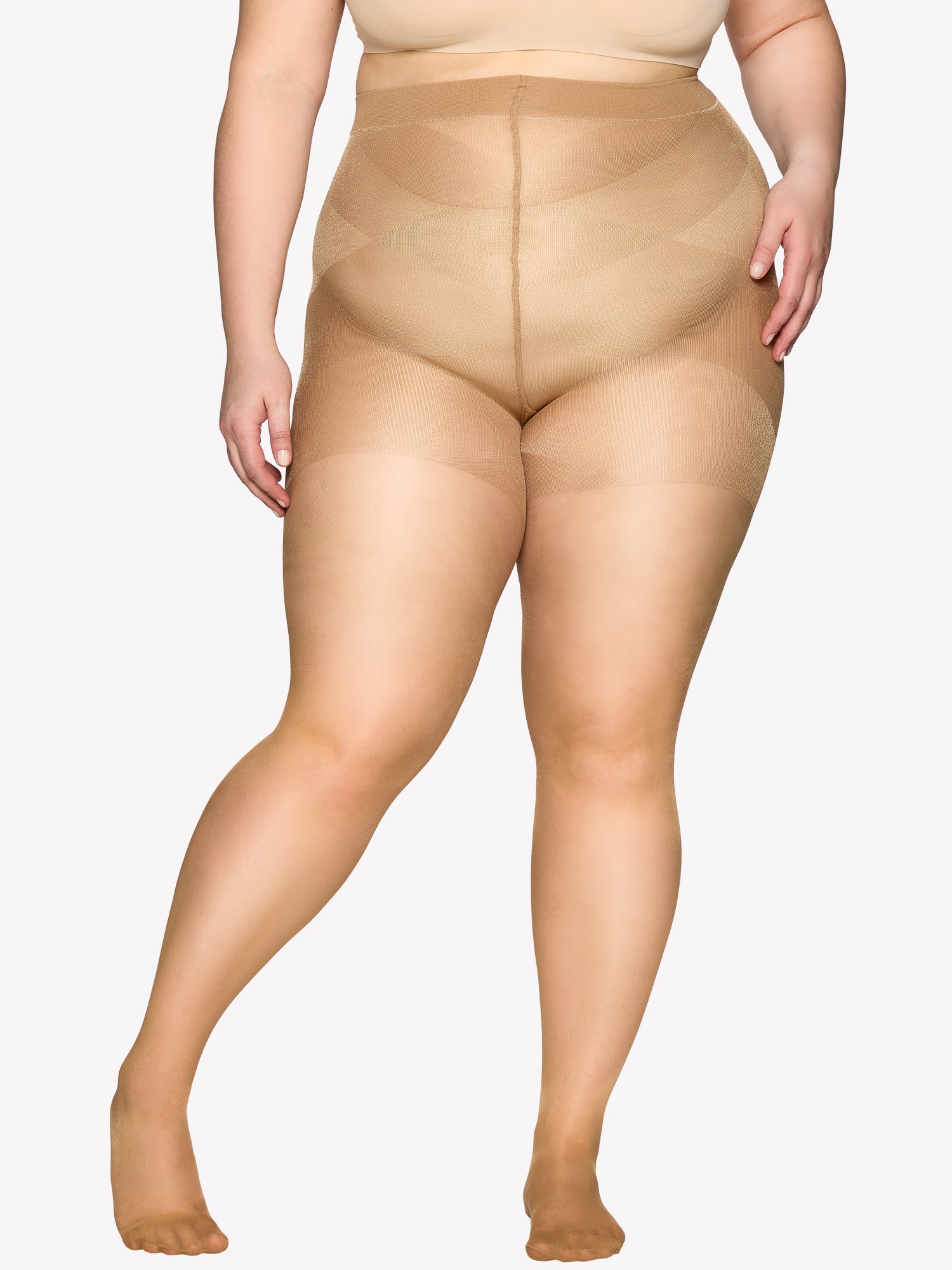 Vogue women's Curvy 40 denier sheer semi-matte tights, expertly crafted for curvy figures with elastic waistband  and a light panty part without panel gusset, on a model from the front.