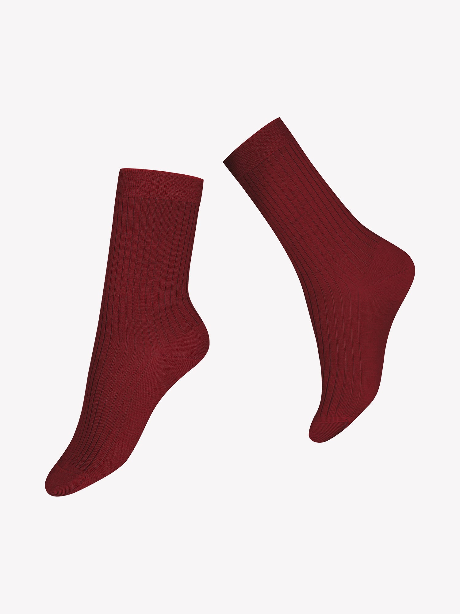Vogue's scarlet red Merino wool socks with classic rib texture in a product picture.