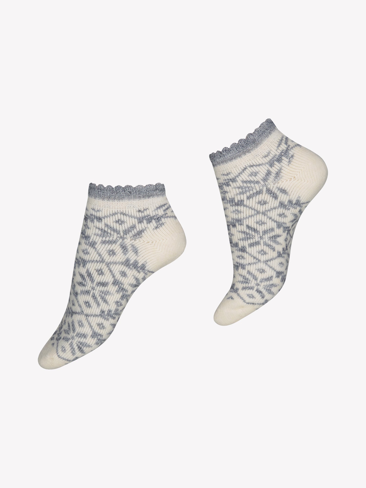 Vogue's off-white sneaker socks from wool blend in a product picture. The socks have a grey fair isla pattern and a cute picot edge.
