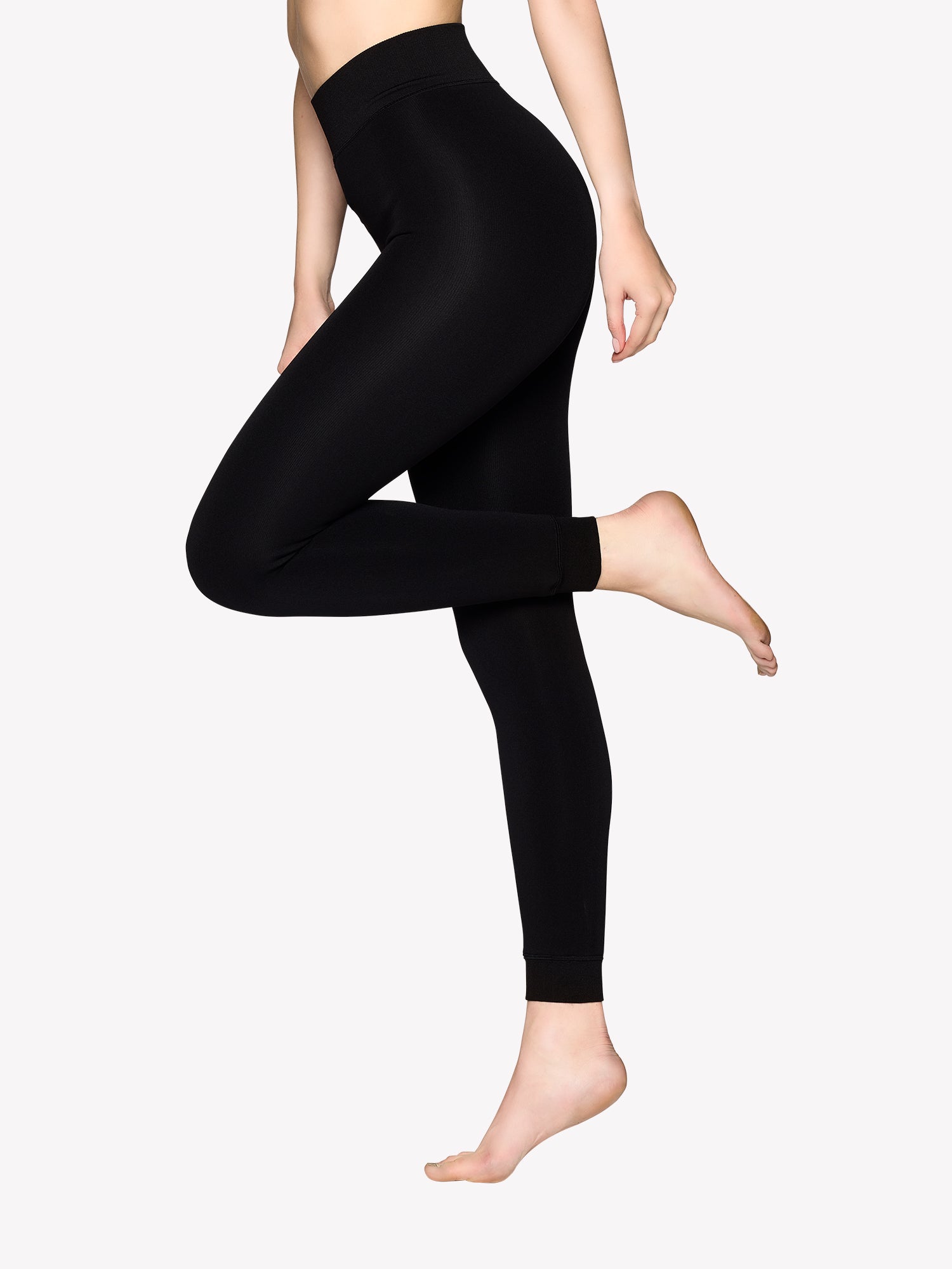 Vogue's black thermo leggings on a model in a picture.