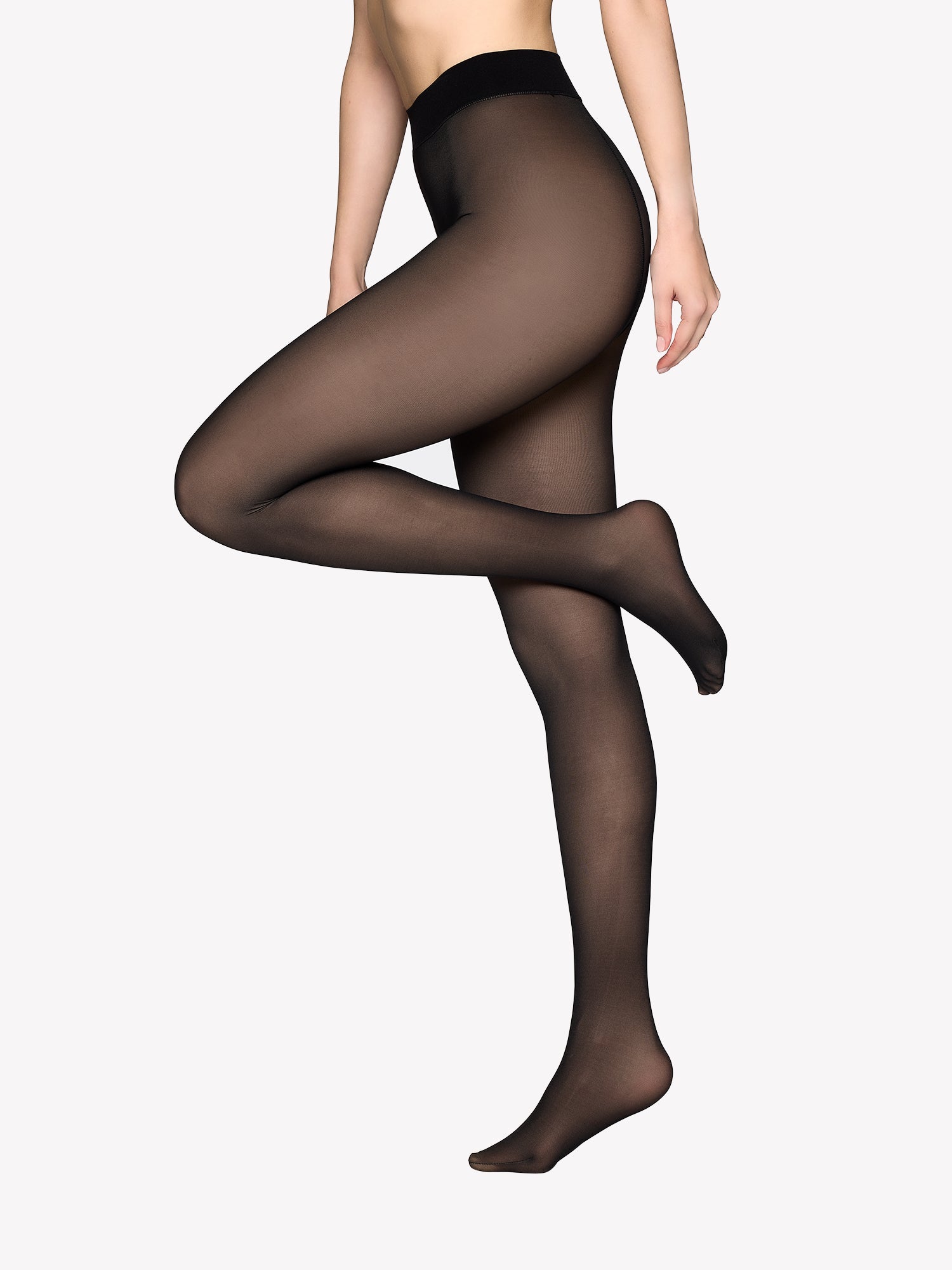 Thermal winter tights with a semi-sheer effect on a model. These winter tights featuring a double-layer design. 