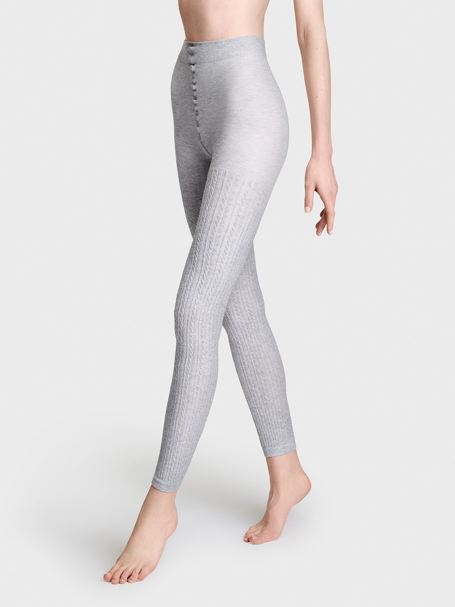 Vogue's classic melange grey viscose leggings with a beautiful cable knit pattern, on a model