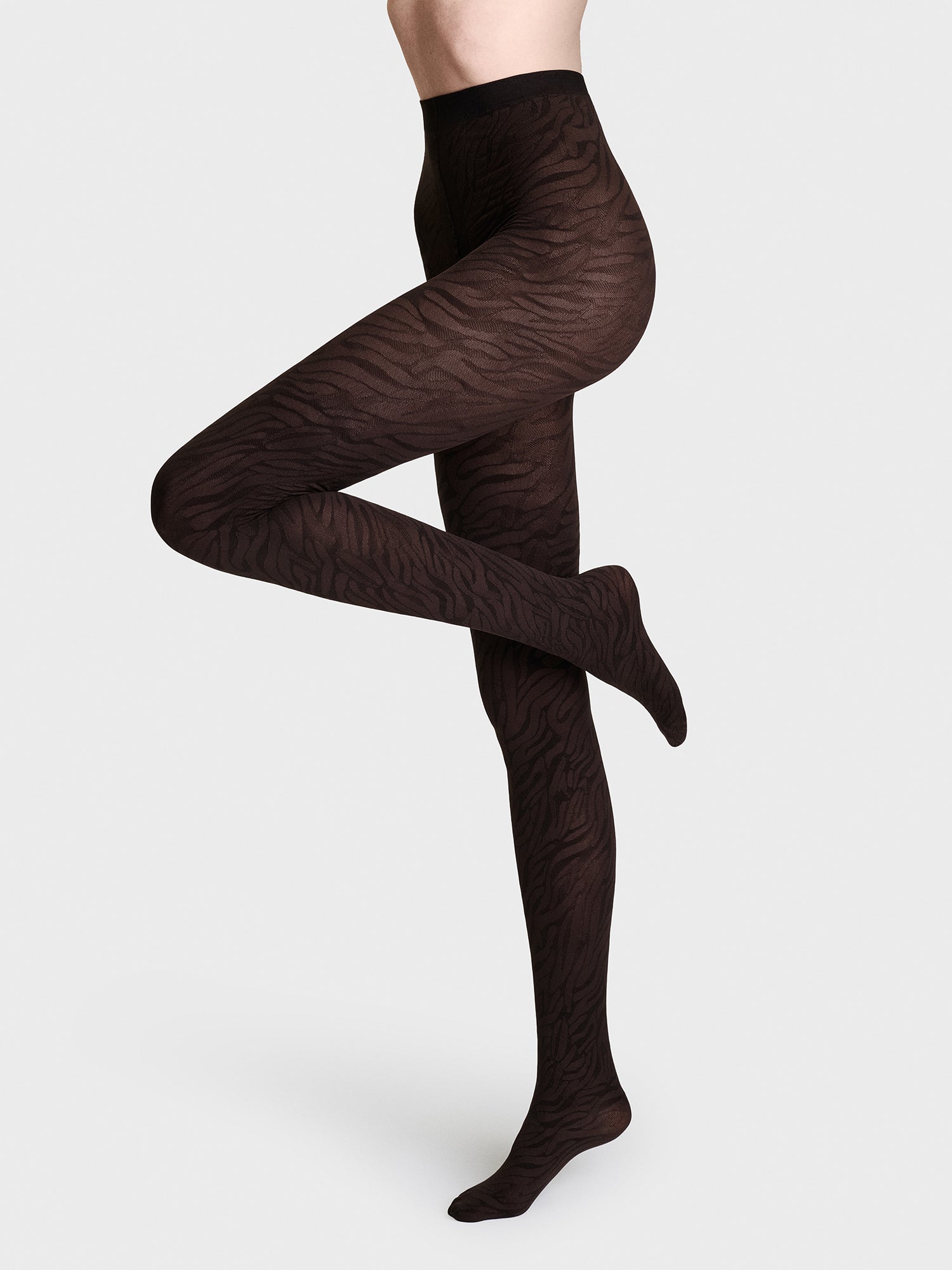 Trendy brown 70 denier animal print tights on a model 
