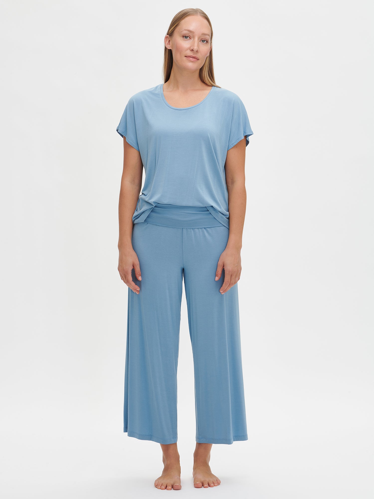 Nanson women's luxuriously soft solid blue Hento pants with a comfortable waistband and a wide, supportive double band, paired with the matching blue Hento top from the same collection, worn by the model.