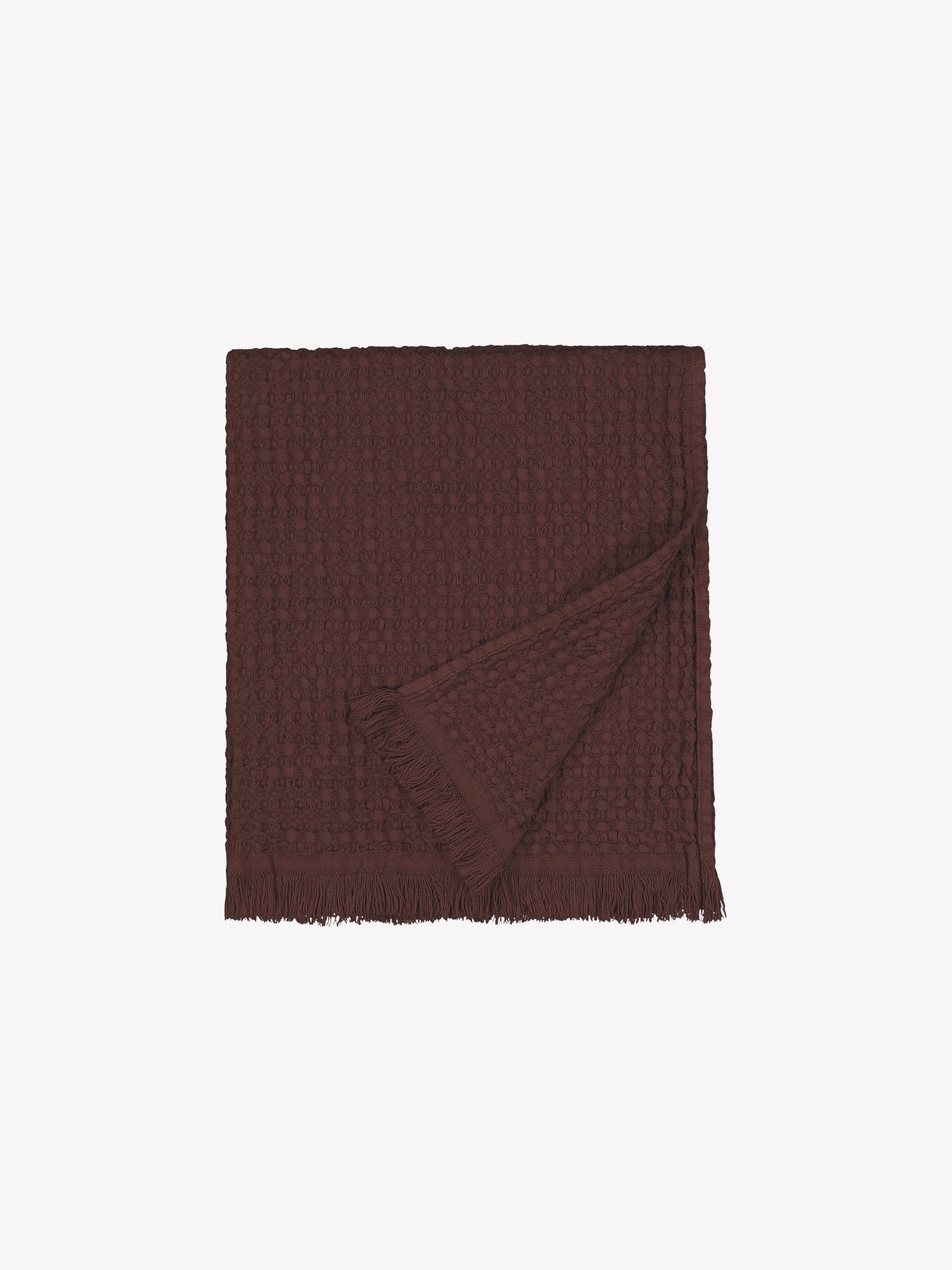Vohveli hand towel in brown made from waffle fabric folded