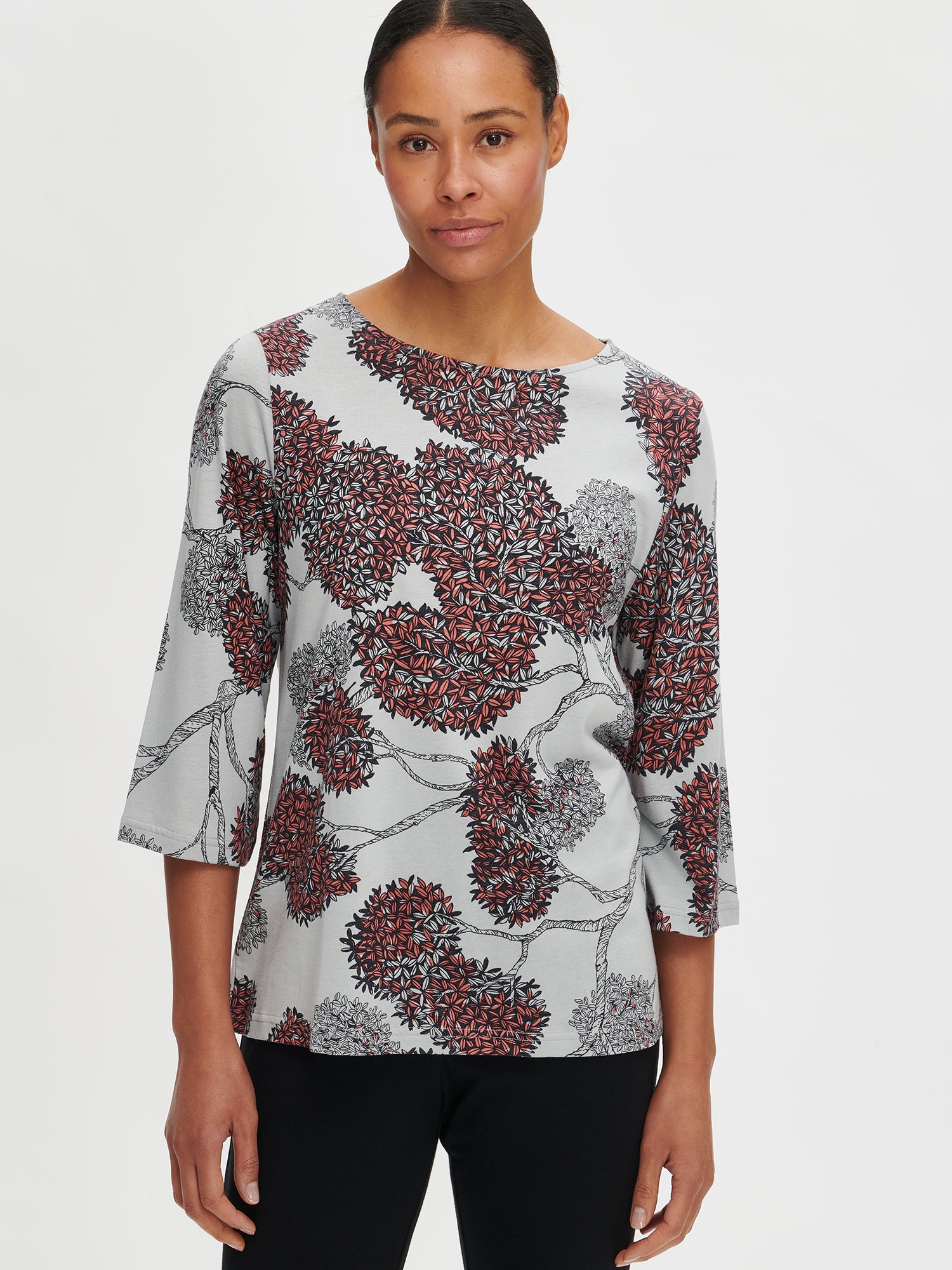 Nanso women’s patterned grey Tuomi pyjama with 3/4 length sleeves and an oval neckline, worn by the model in a close-up shot.