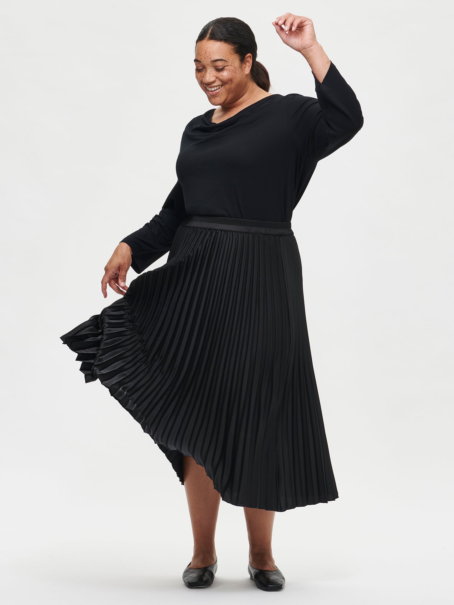 Nanso's elegant Taite skirt for women features a graceful drape in a classic black, front