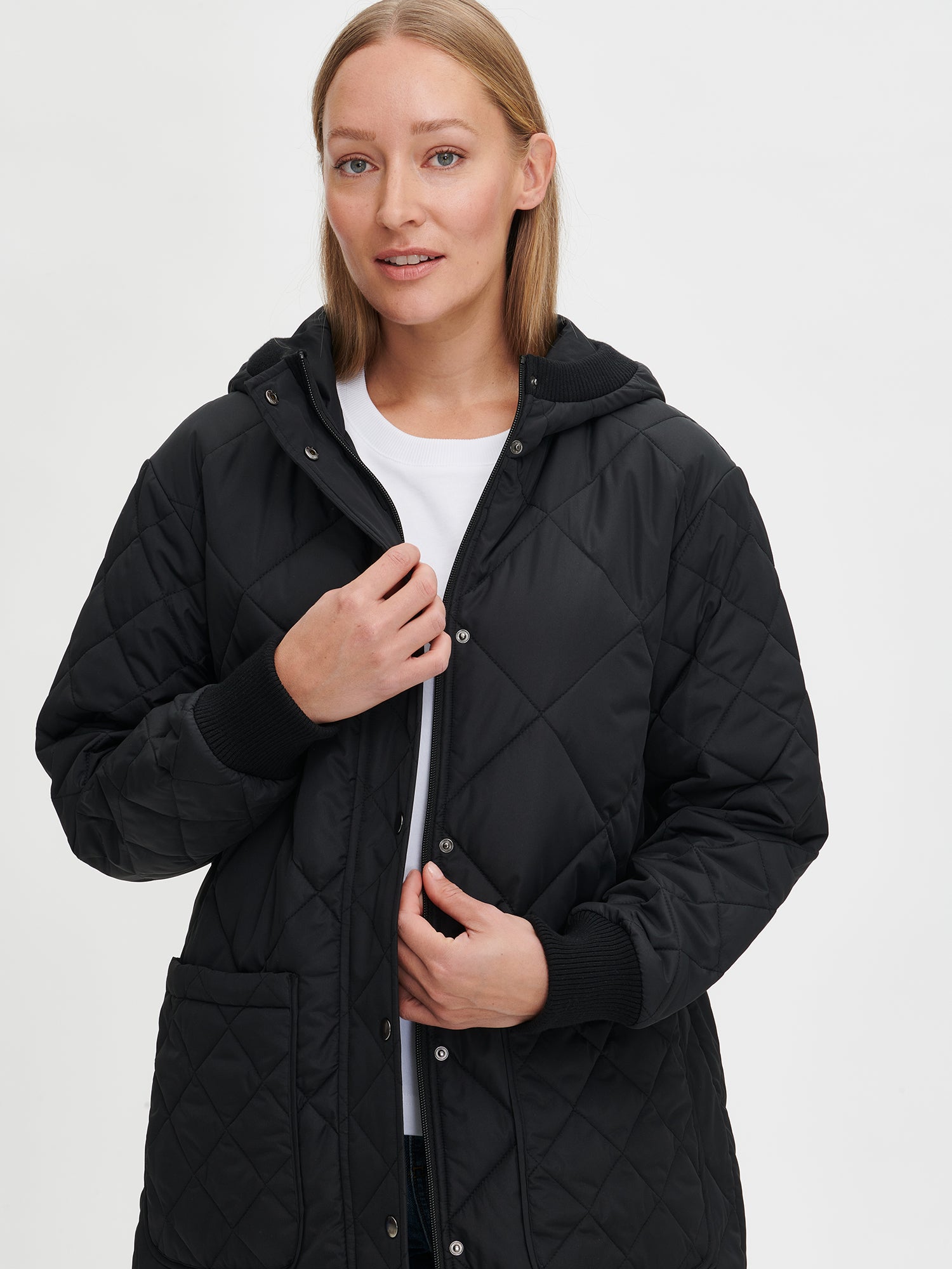 Nanso women's casual black Maxi quilted coat with light padding and a cozy hood.  On a model in size S, close-up.