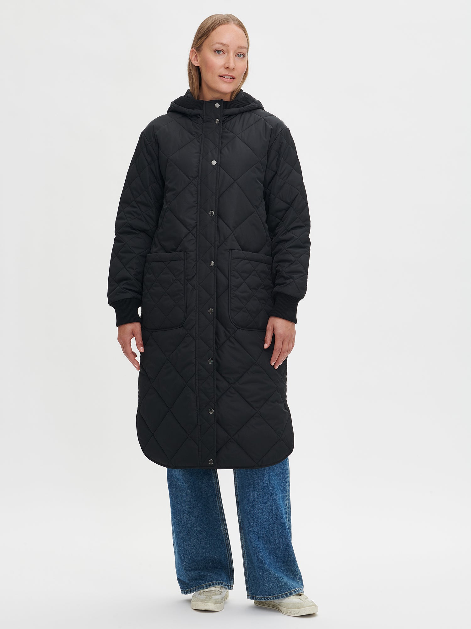 Nanso women's casual black Maxi quilted coat with light padding and a cozy hood.  On a model in size S, front.
