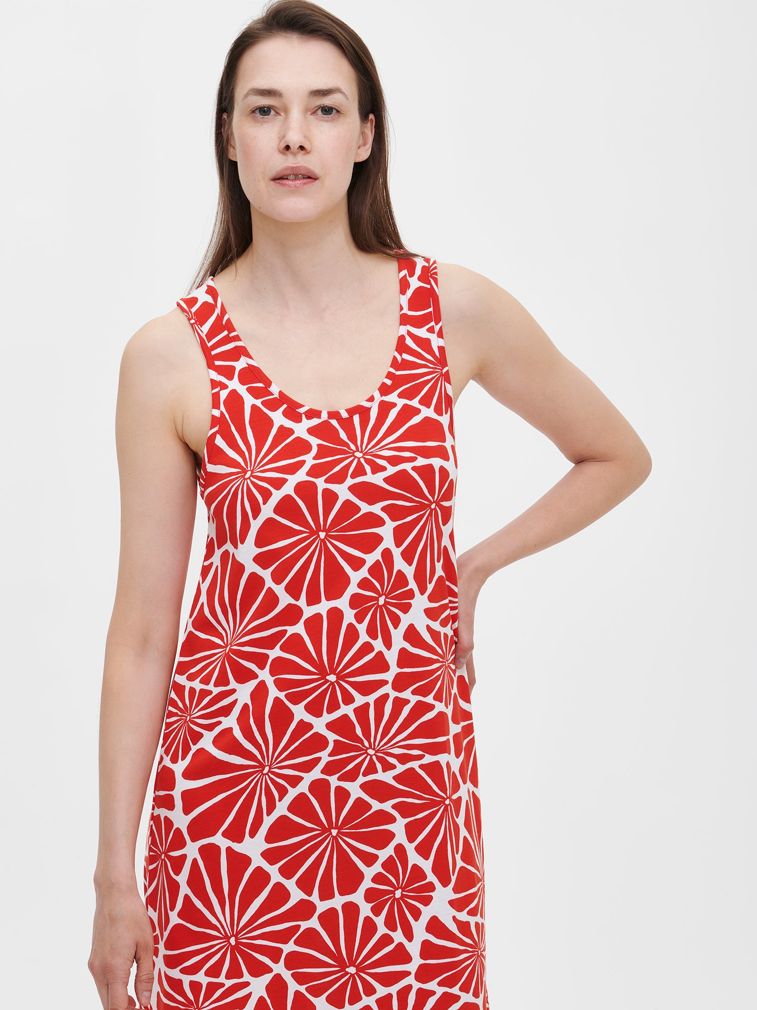 Nanson women's floral-patterned red Aralia nightdress with a round neckline and side pockets, worn by the model in a close-up front view.