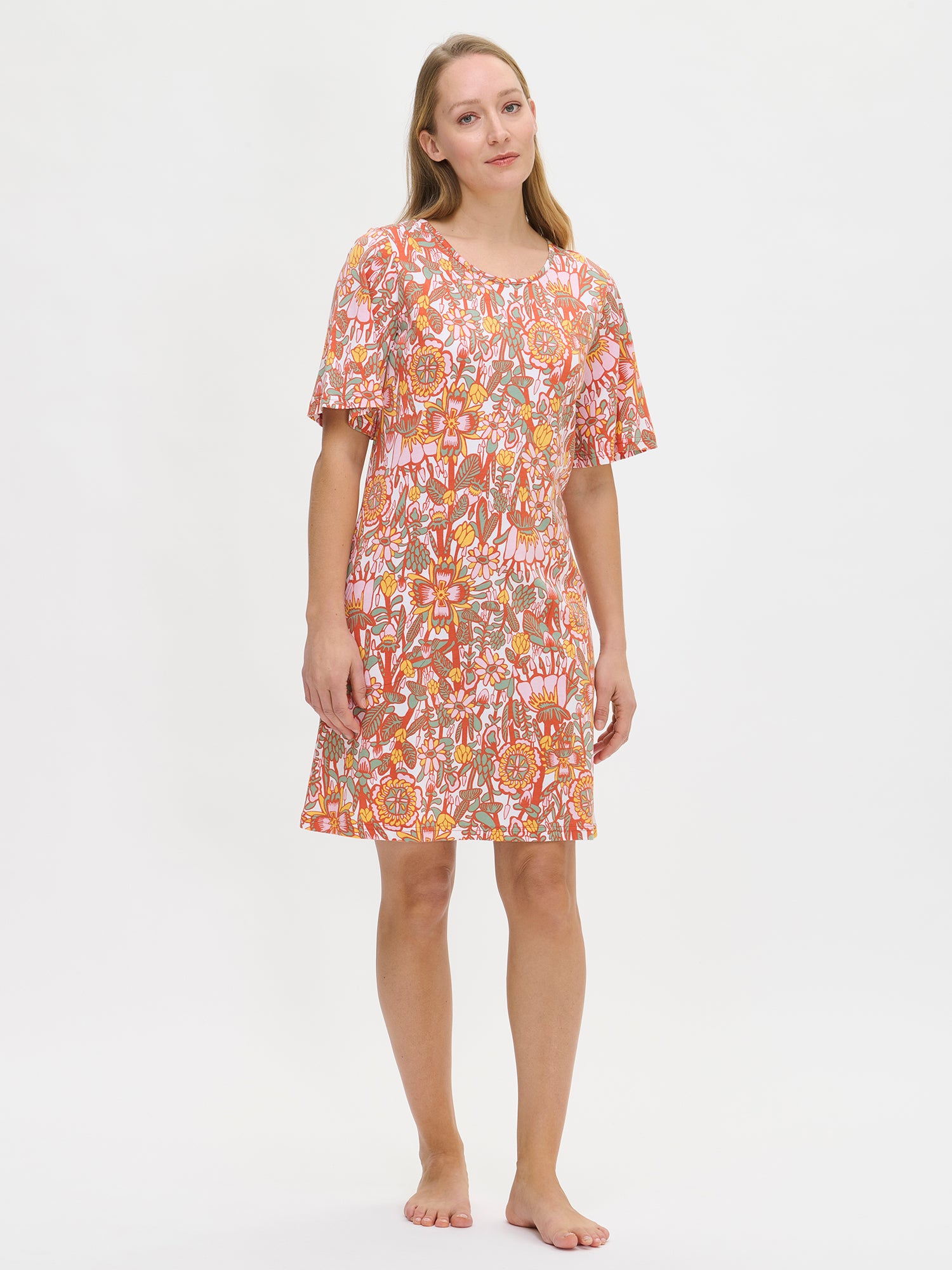 Nanso women's floral-printed, knee-length multicolored Oodi nightgown with short flared sleeves, a round neckline, and side pockets, worn by the model.