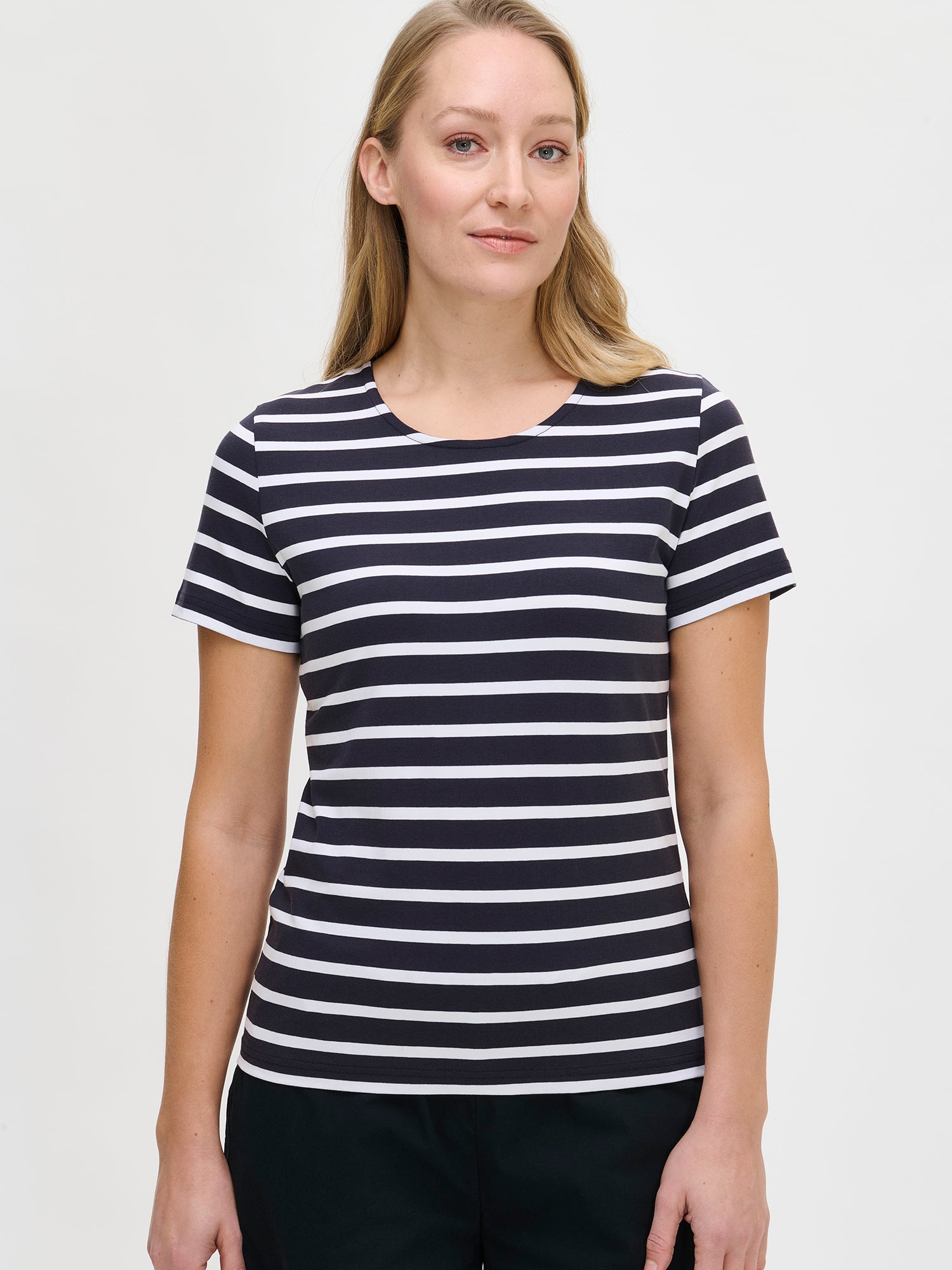 Nanso women's dark blue striped Marianne t-shirt, with a wide round neckline finished with binding and short sleeves, shown on the model in a close-up.