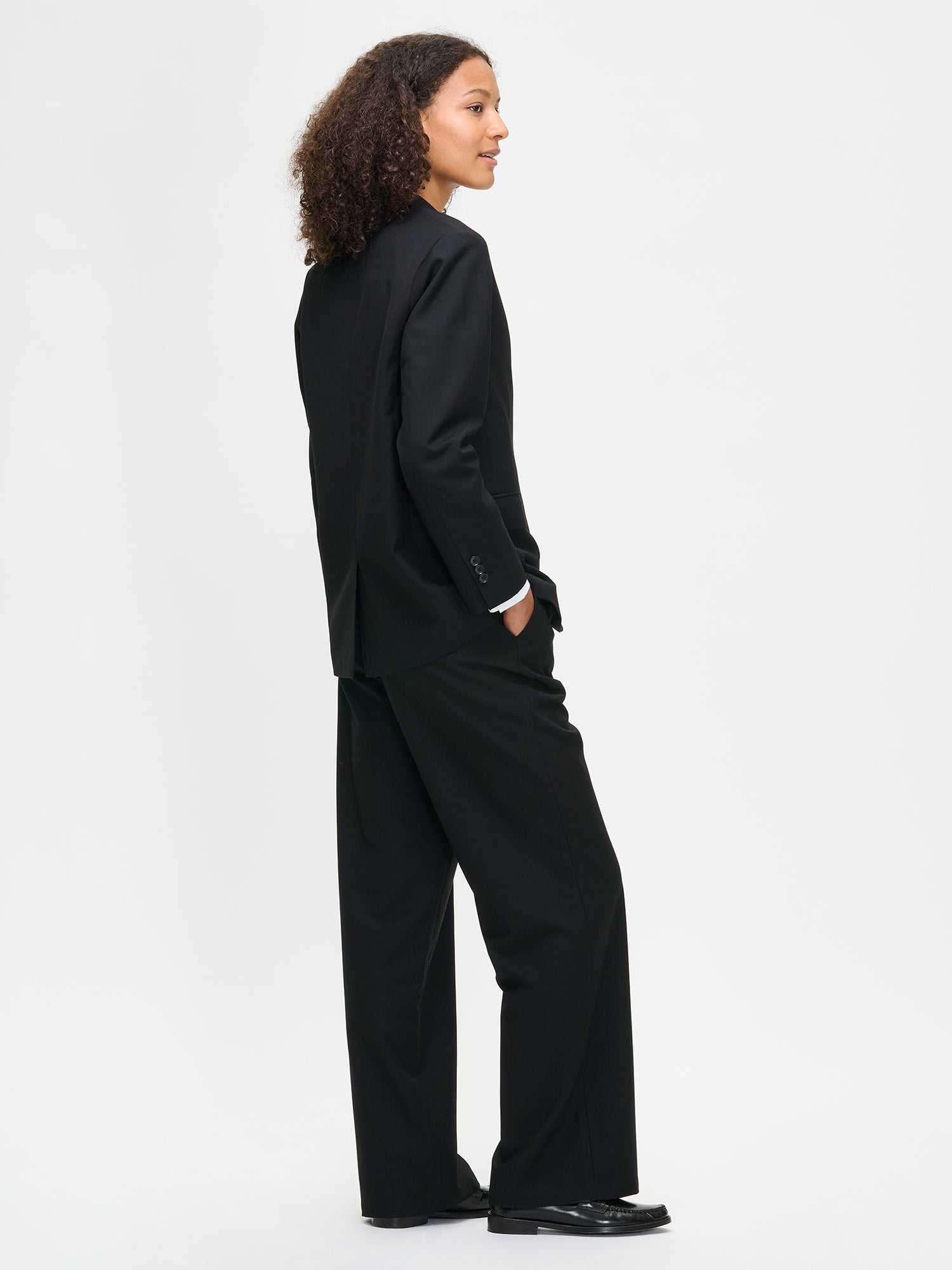 Nanso women's black Bea trousers on a model, from the back