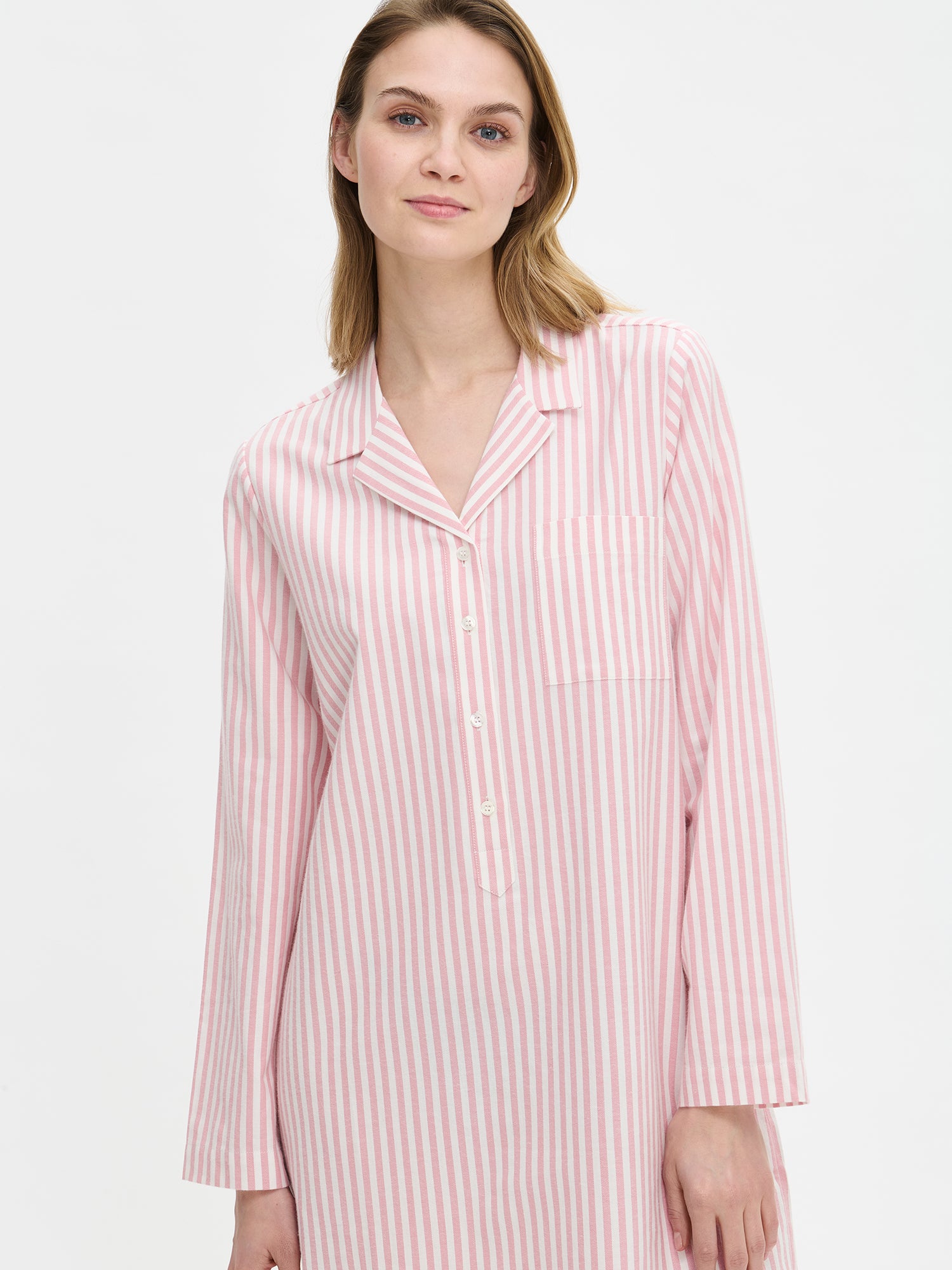 Nanso Polka pink women’s striped flannel dress with button placket and chest pocket, half-body image worn by model.