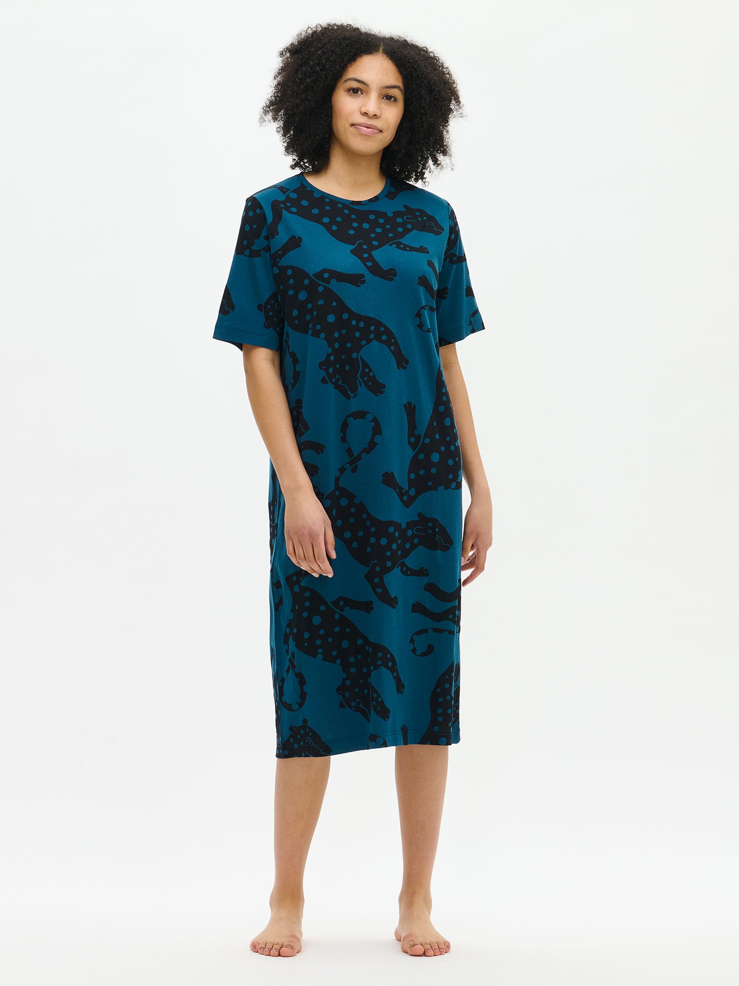 Nanso women’s long blue Leonora nightgown with elbow-length sleeves and round neckline, worn by model from the front. Straight-cut hem falls below the knees.