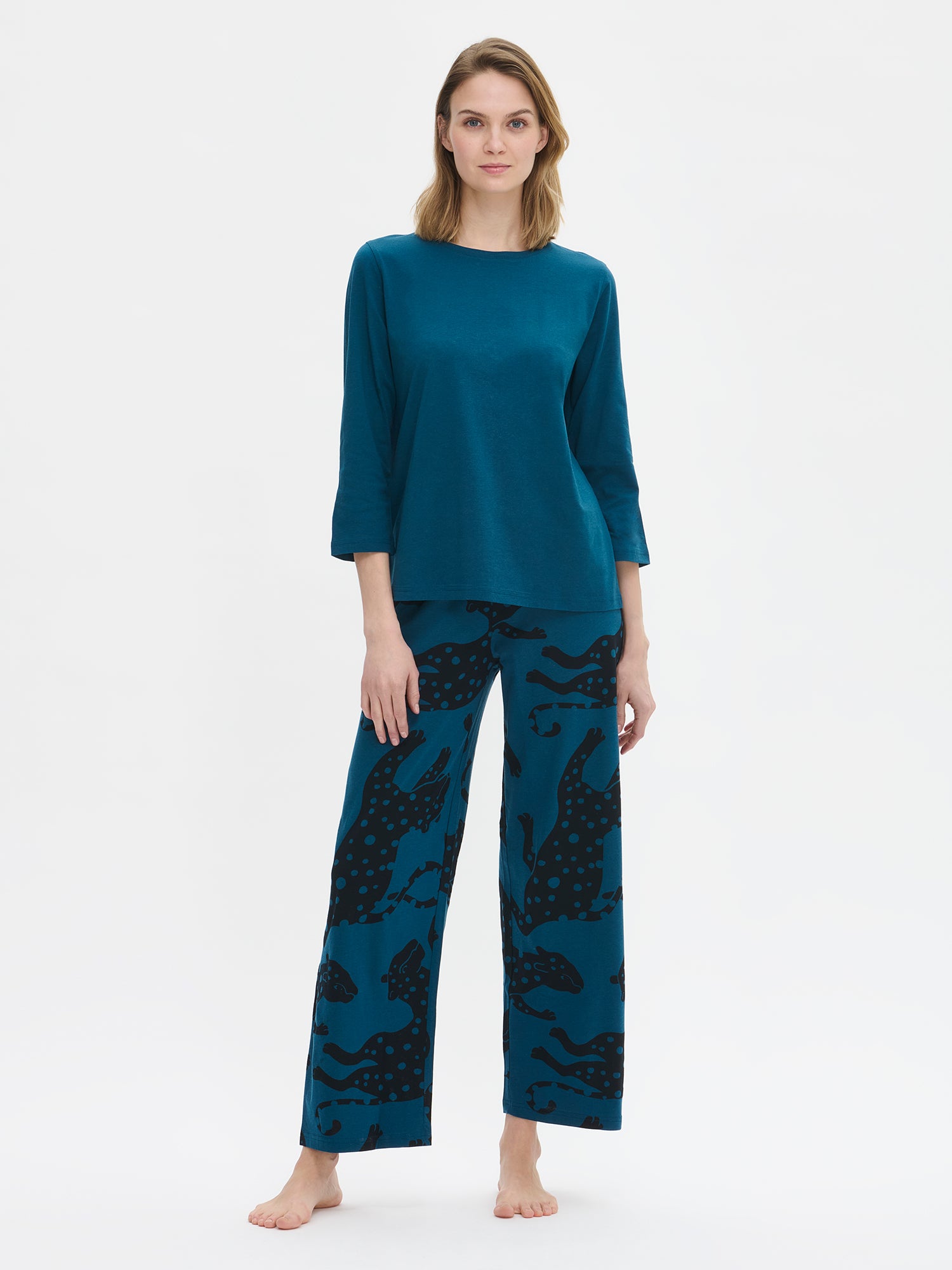Nanso women’s Leonora pyjama set with blue 3/4-sleeve top and printed 7/8-length trousers, worn by model from the front.