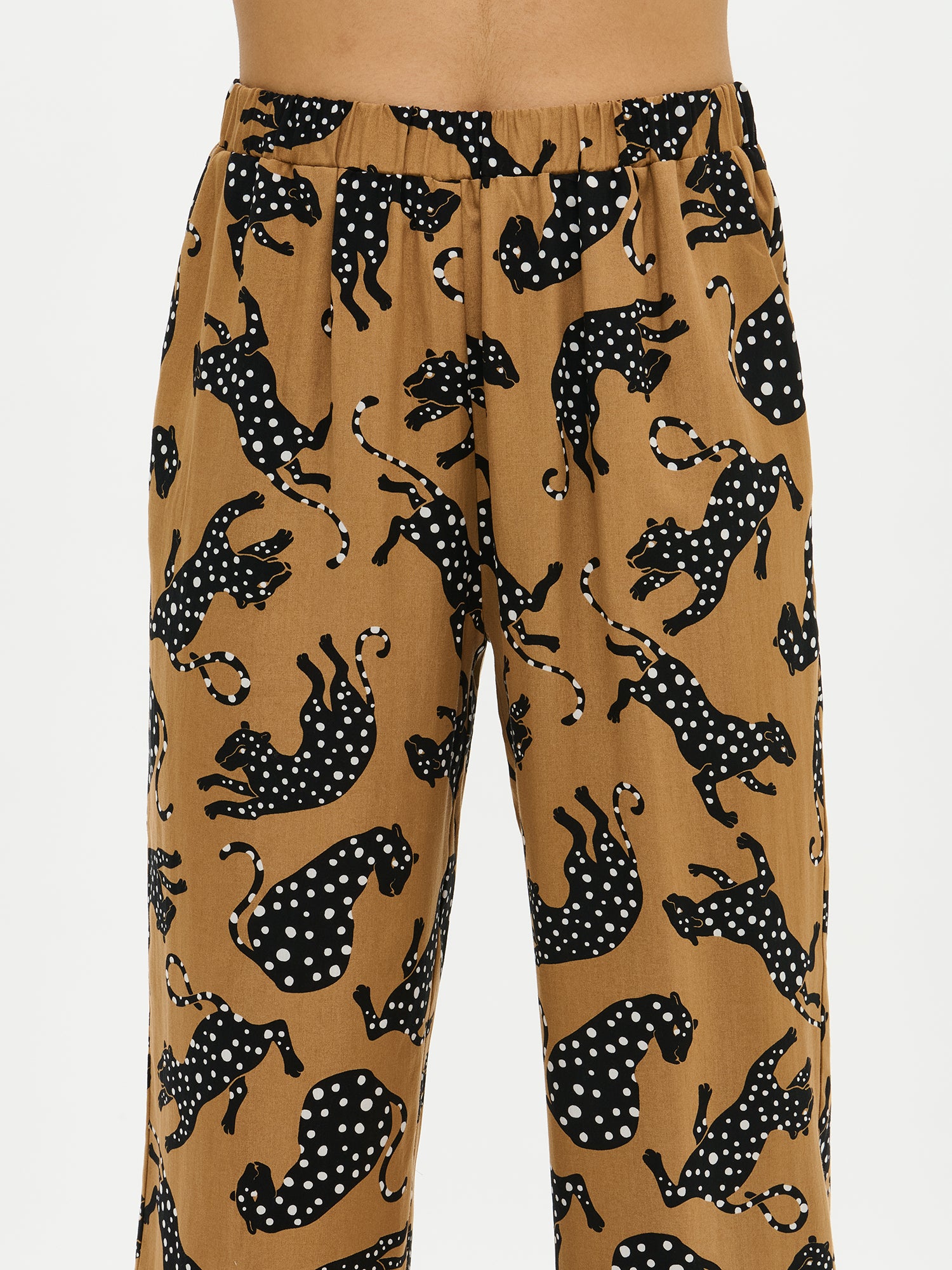 Nanso women’s patterned beige trousers, shown on a model side view with straight legs and side pockets.