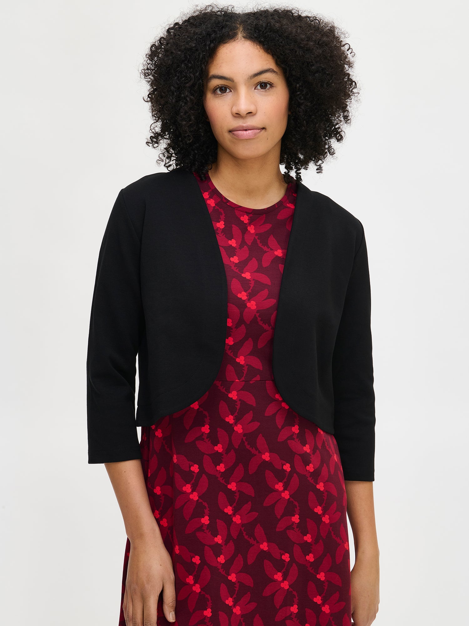 Nanso women’s black Opera bolero, short waist-length design with round neckline and curved hem, worn by model in close-up photo.