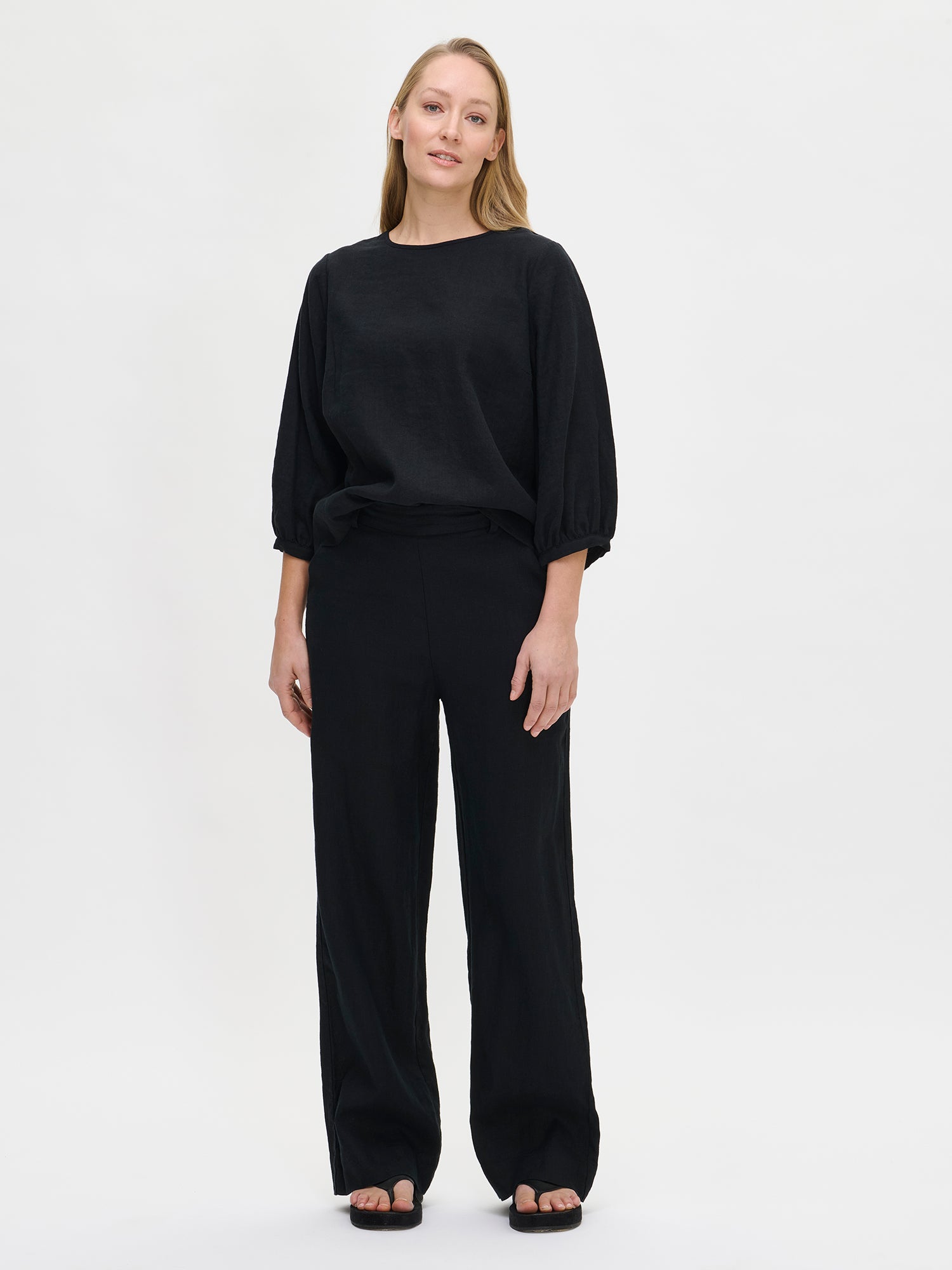 Women's Saralia linen Blouse in black is a timeless addition to any wardrobe, easily paired with different outfits for various occasions. Worn by a model in size S.